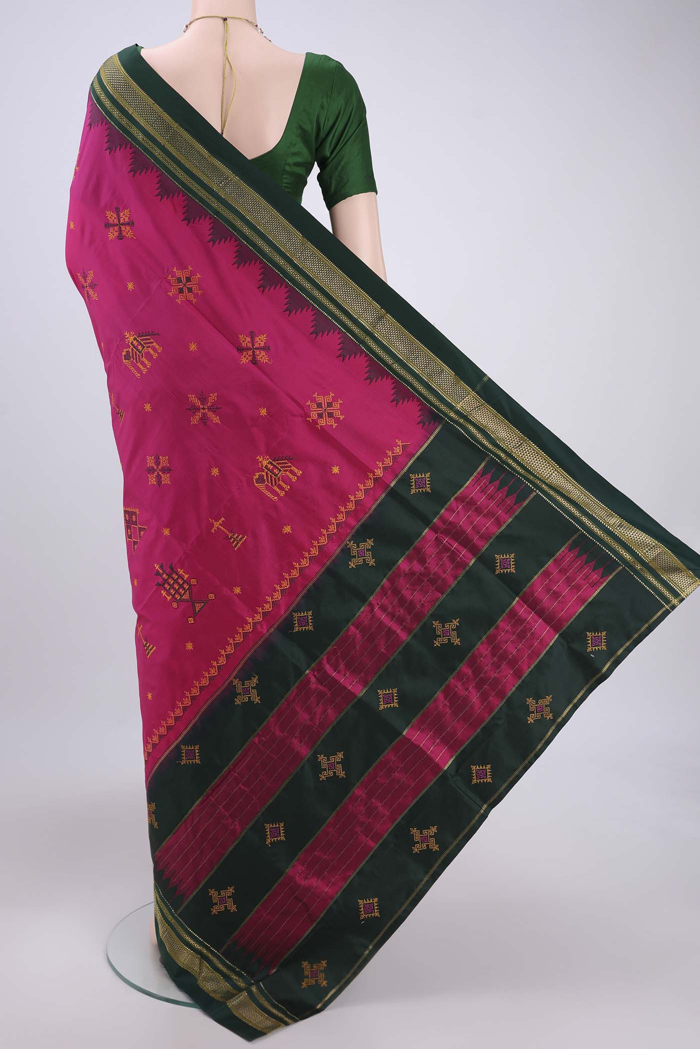 Flat view of Rani Pink Bangalore Silk Saree with Embroidery on the body and Temple Border. 