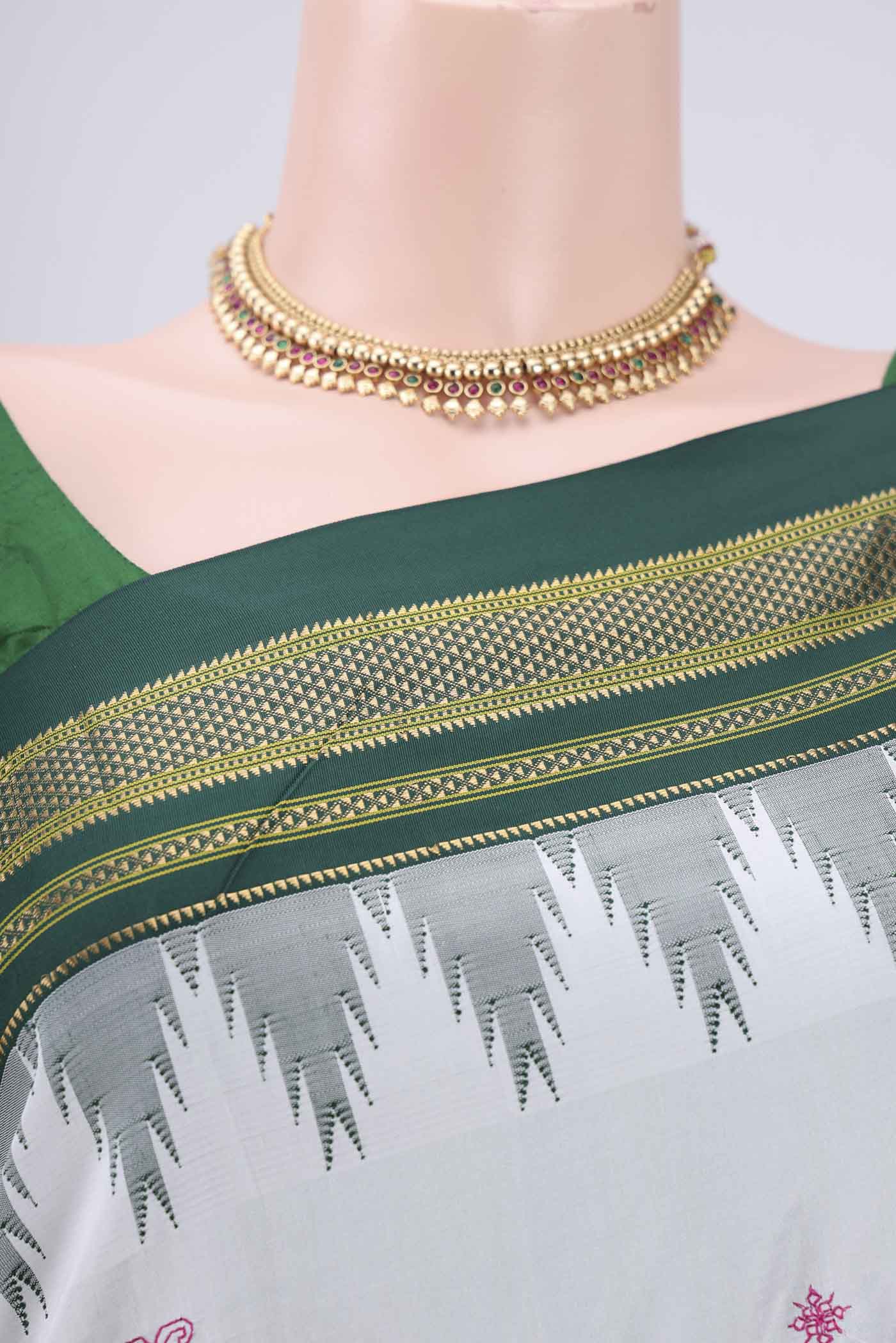 Border image of White Bangalore Silk Saree with Embroidery on the body and Temple Border. 