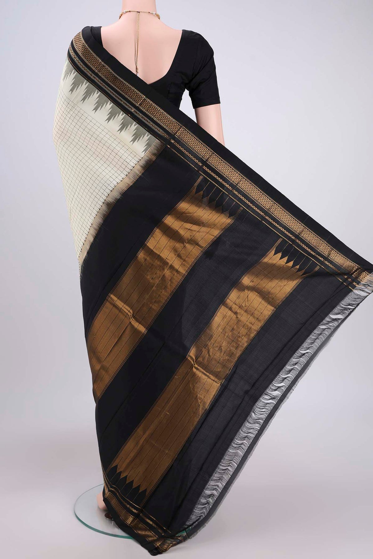 Flat view of Off White Bangalore Silk Saree with Checked design on the body and Temple Border. 
