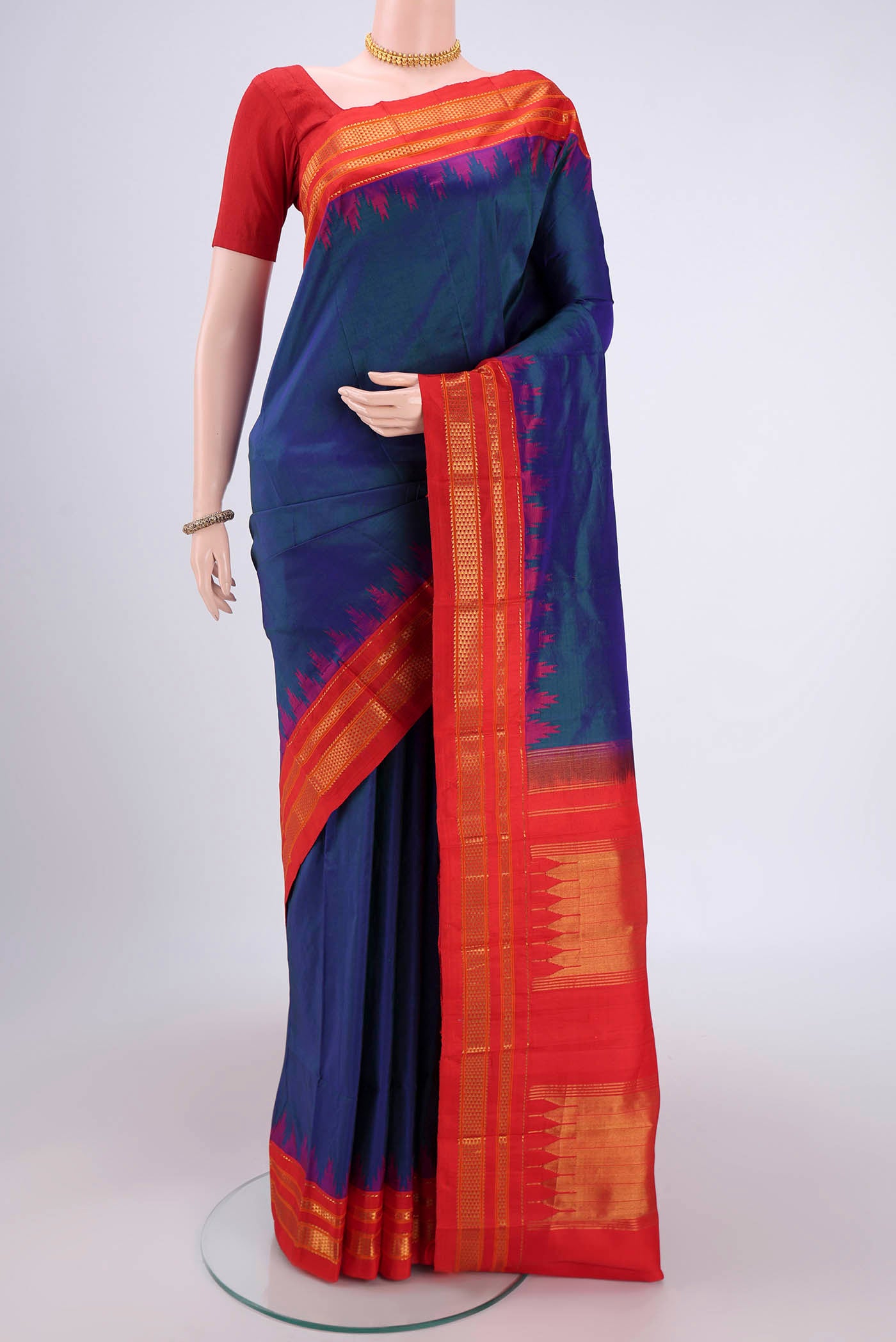 Peacock Blue Bangalore Silk Saree with Plain Body and Temple Border.  displayed on a mannequin