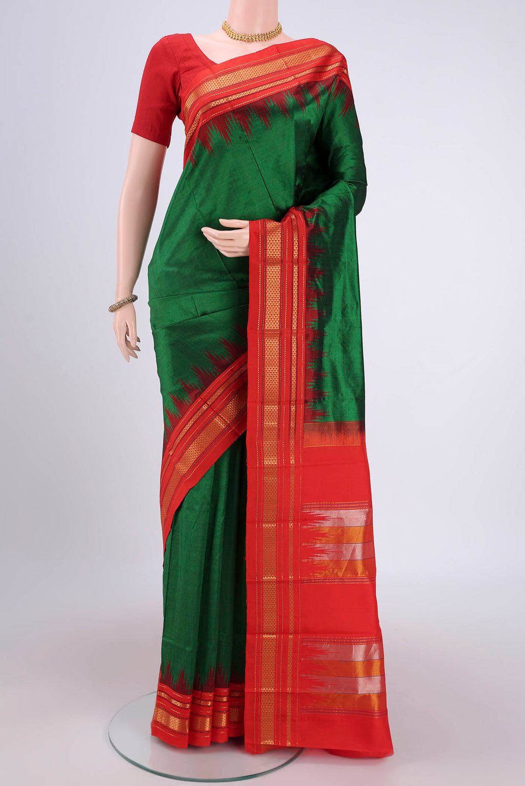 Bottle Green Bangalore Silk Saree with Plain Body and Temple Border.  displayed on a mannequin