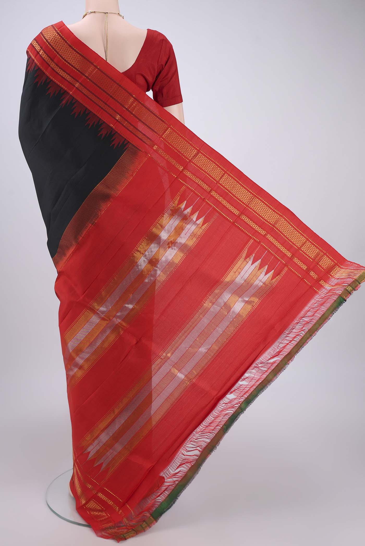 Flat view of Black Bangalore Silk Saree with Plain Body and Temple Border. 