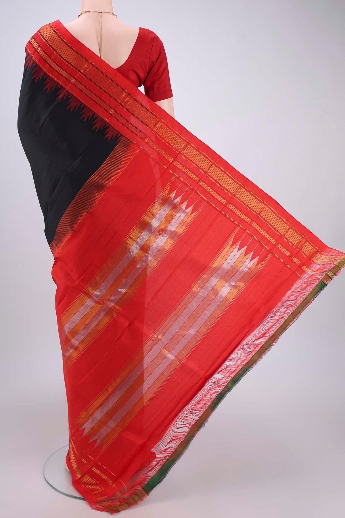 Flat view of Black Bangalore Silk Saree with Plain Body and Temple Border. 