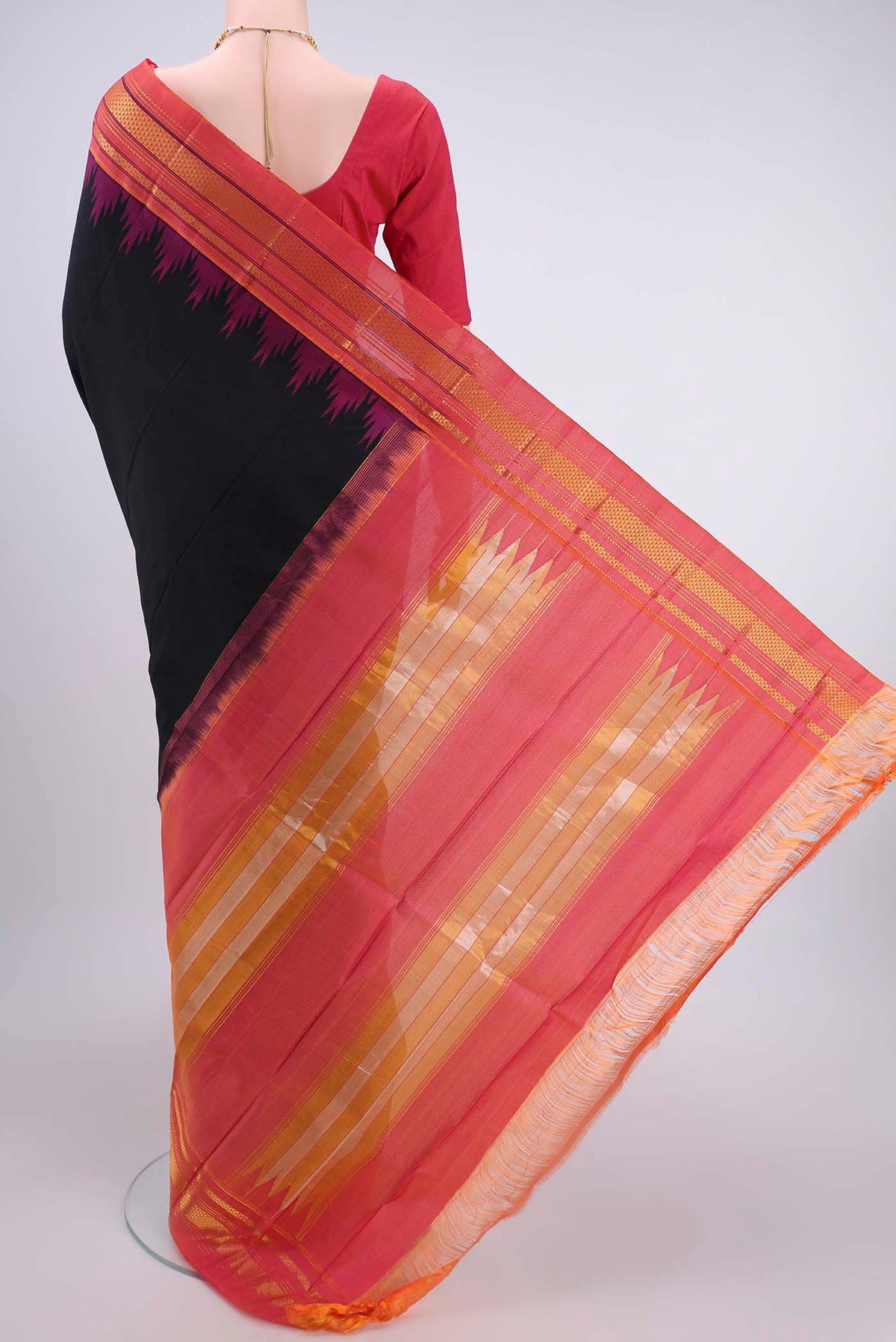 Flat view of Black Bangalore Silk Saree with Plain Body and Temple Border. 