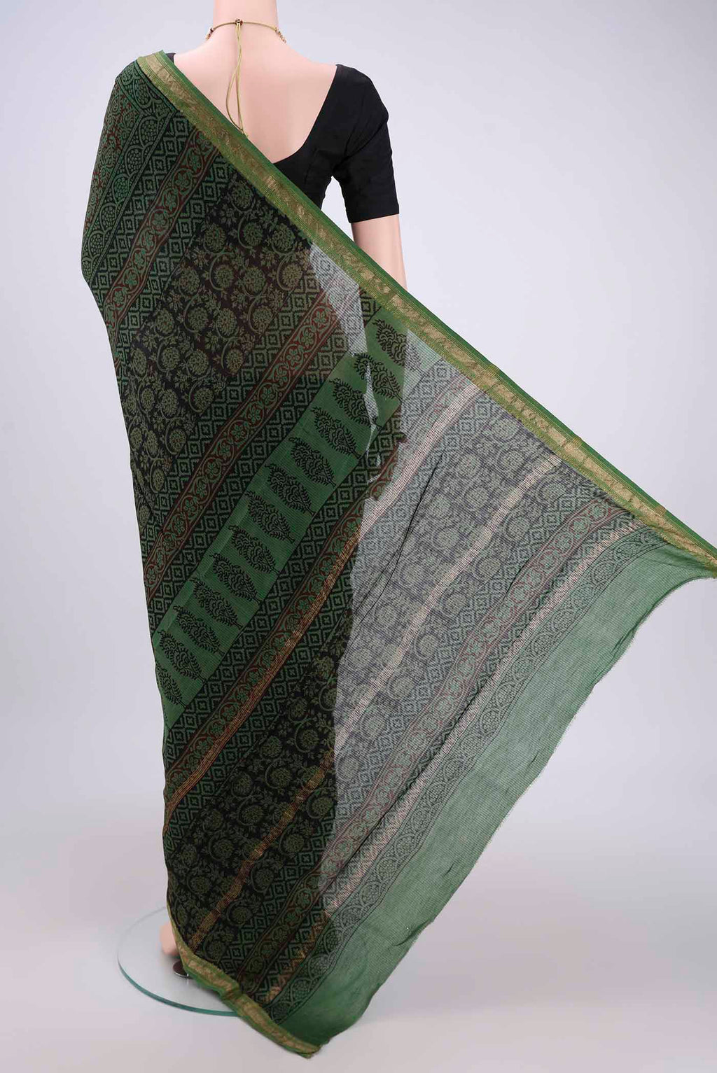 Flat view of Green Maheshwari Silk Cotton Saree with Batik Print on the body and Zari Border. 