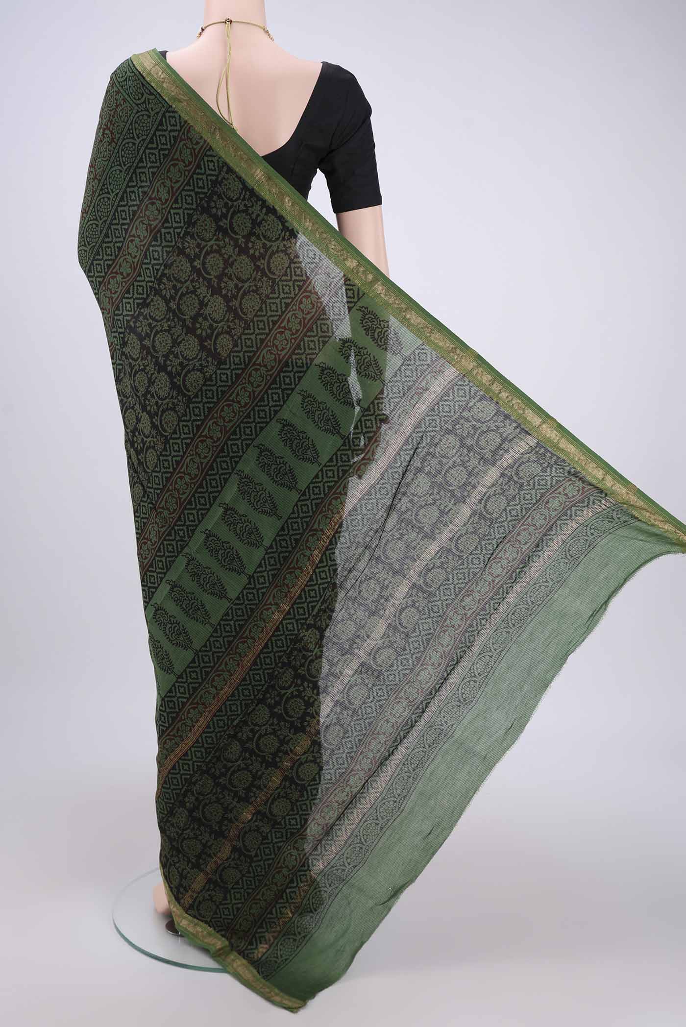 Flat view of Green Maheshwari Silk Cotton Saree with Batik Print on the body and Zari Border. 