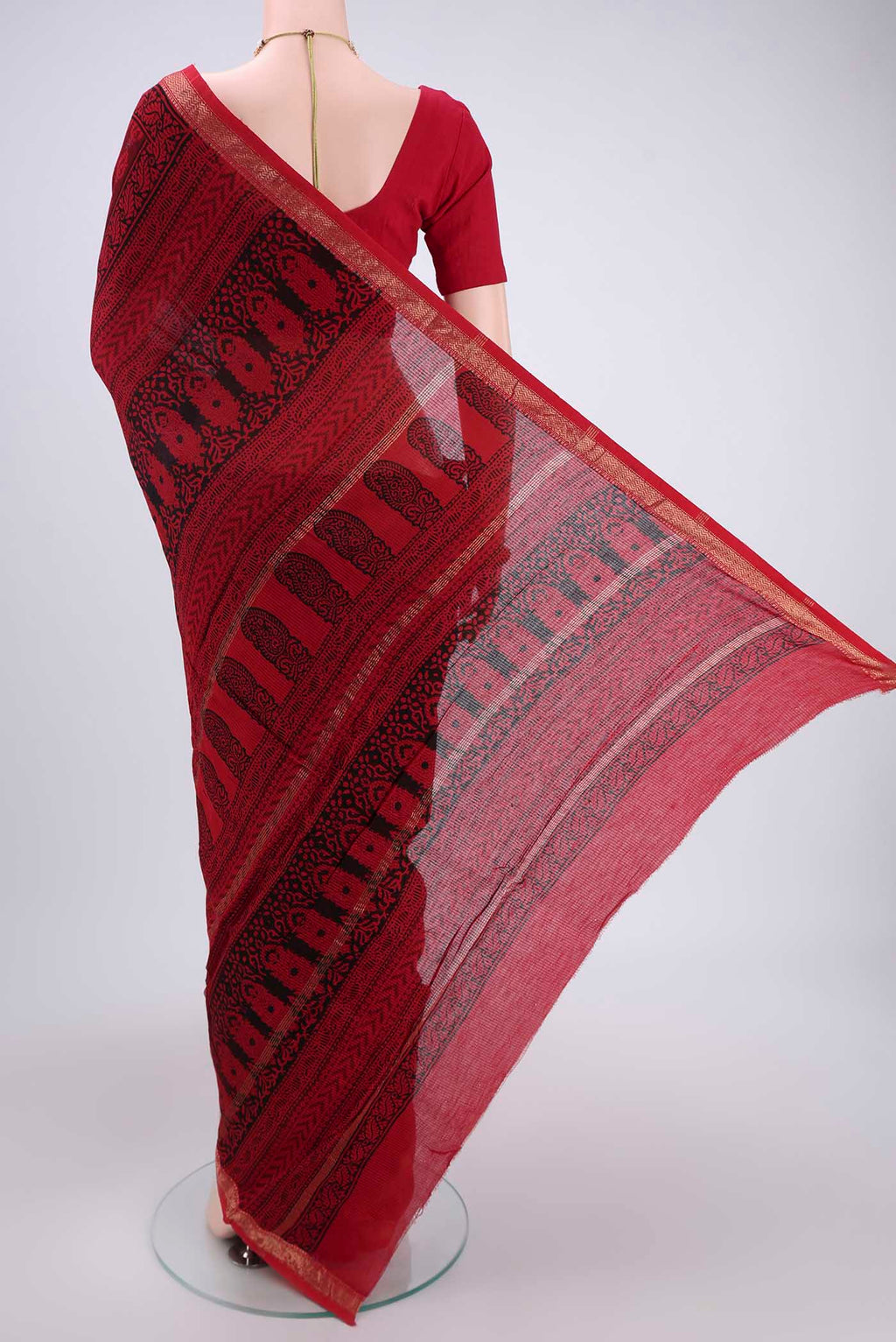 Flat view of Red Maheshwari Silk Cotton Saree with Batik Print on the body and Zari Border. 