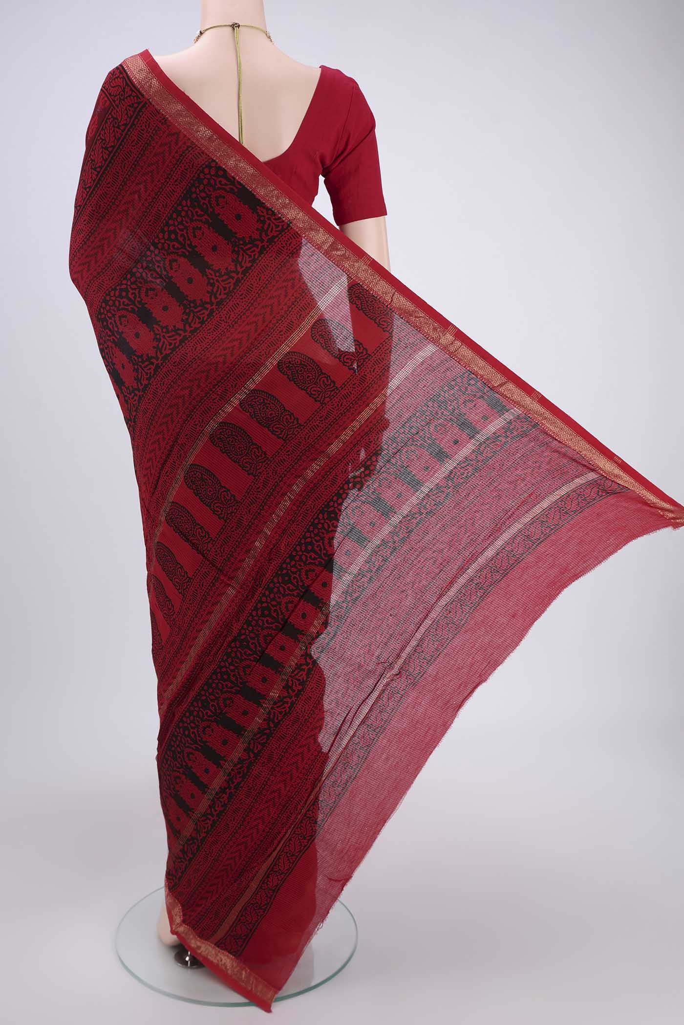 Flat view of Red Maheshwari Silk Cotton Saree with Batik Print on the body and Zari Border. 