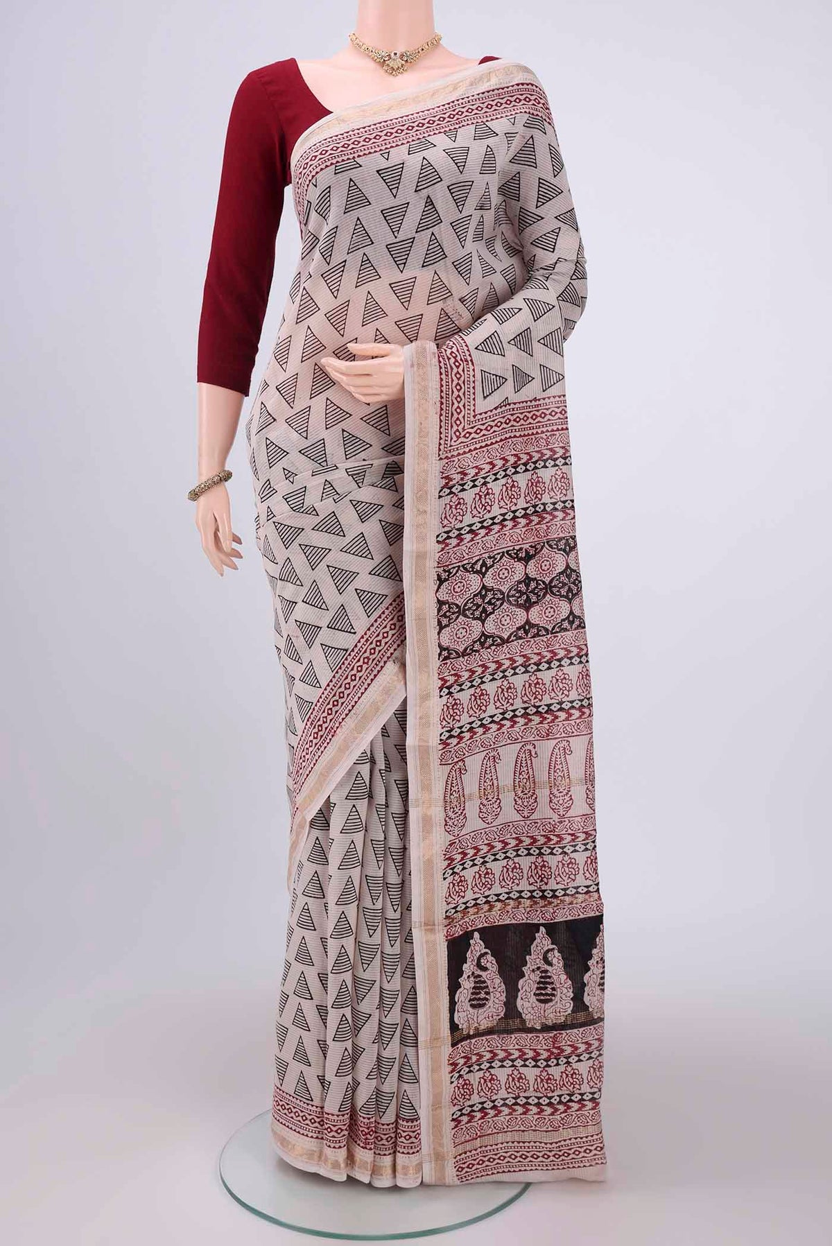 Beige Maheshwari Silk Cotton Saree with Batik Print on the body and Zari Border.  displayed on a mannequin