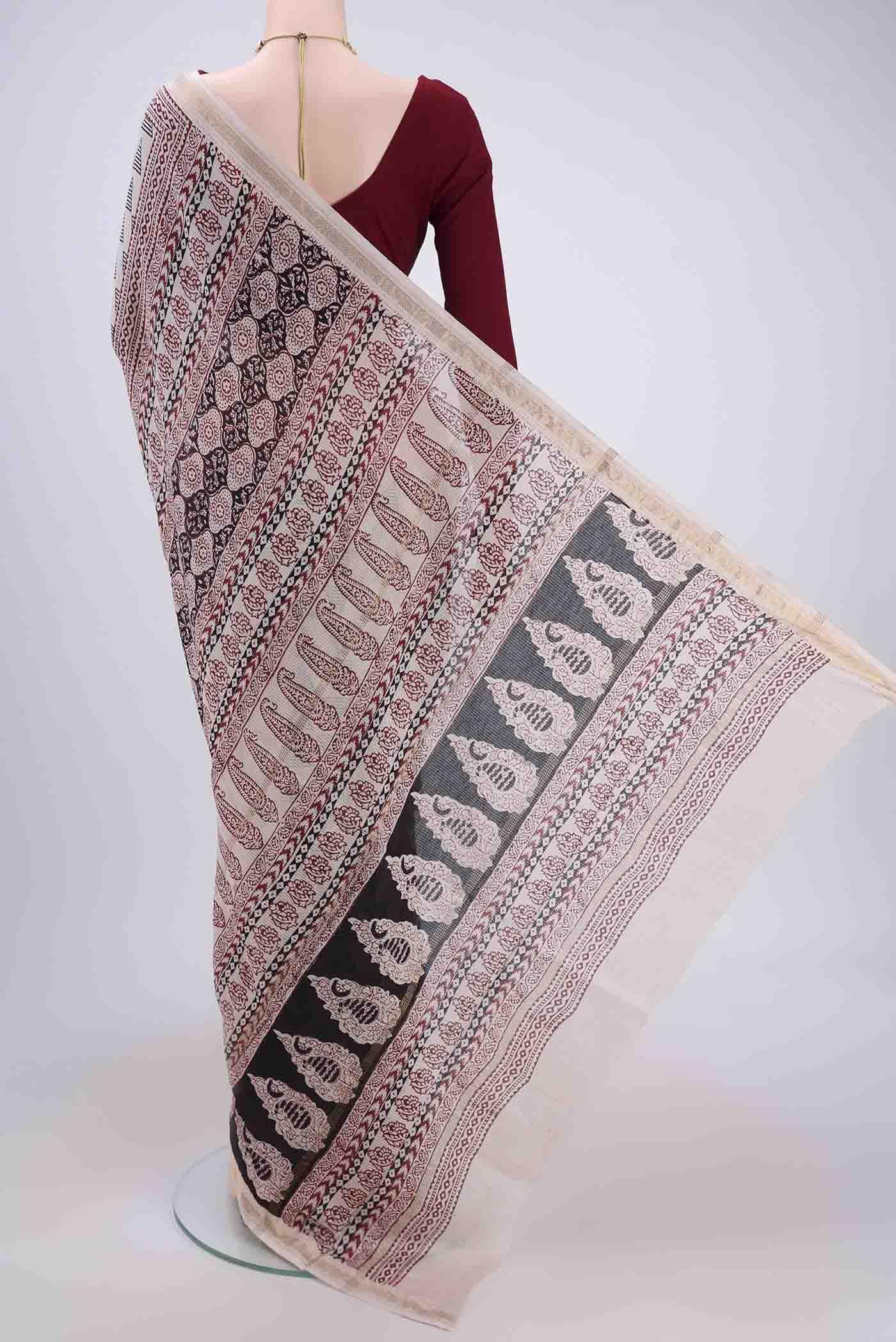 Flat view of Beige Maheshwari Silk Cotton Saree with Batik Print on the body and Zari Border. 