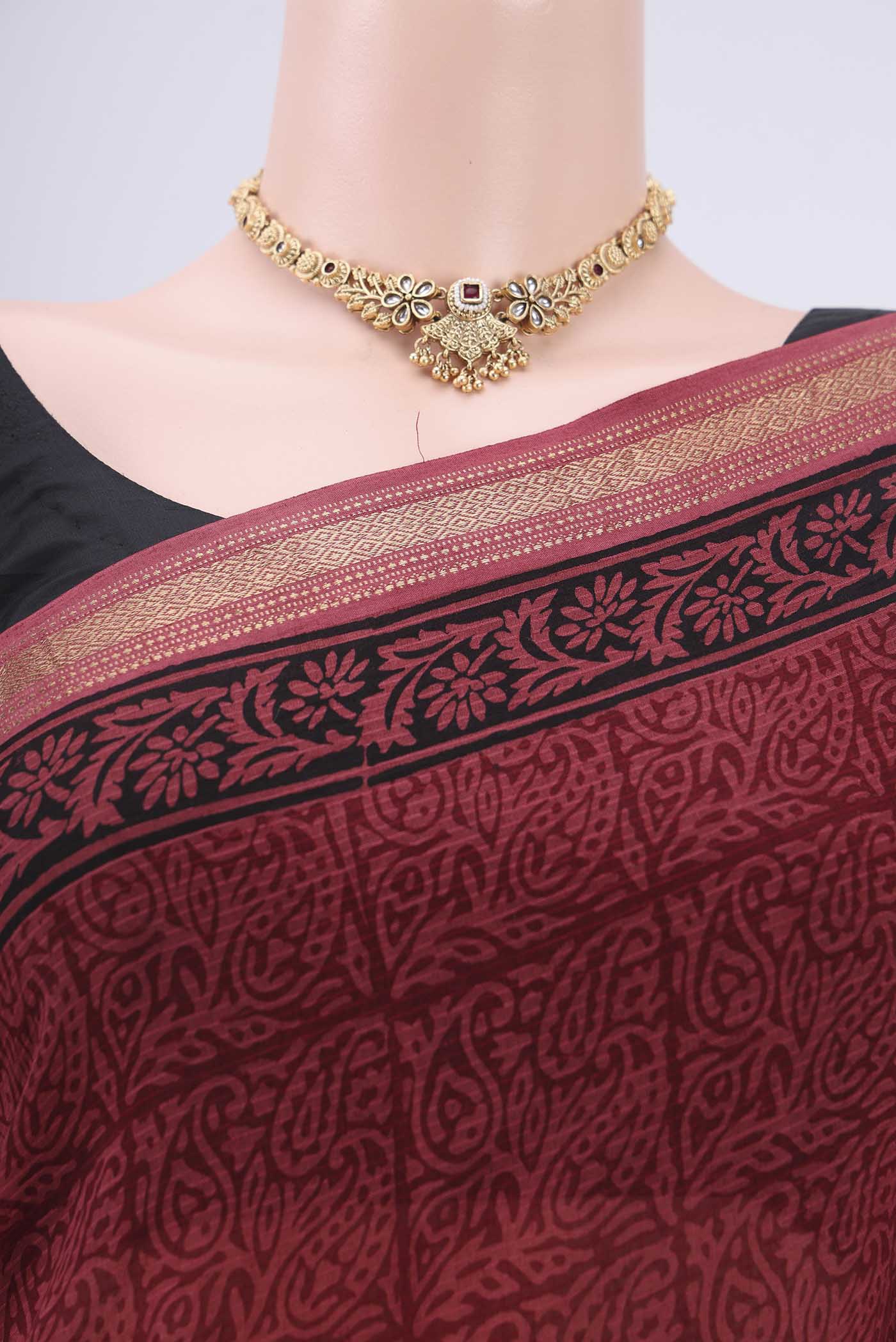 Border image of Maroon Maheshwari Silk Cotton Saree with Batik Print on the body and Zari Border. 
