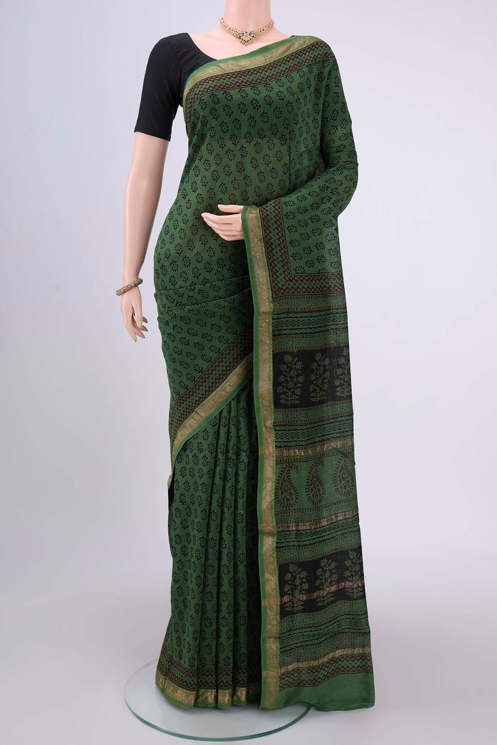 Green Maheshwari Silk Cotton Saree with Batik Print on the body and Zari Border.  displayed on a mannequin