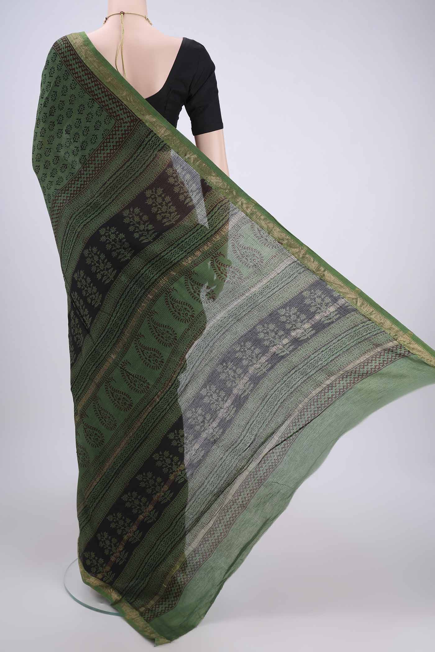 Flat view of Green Maheshwari Silk Cotton Saree with Batik Print on the body and Zari Border. 