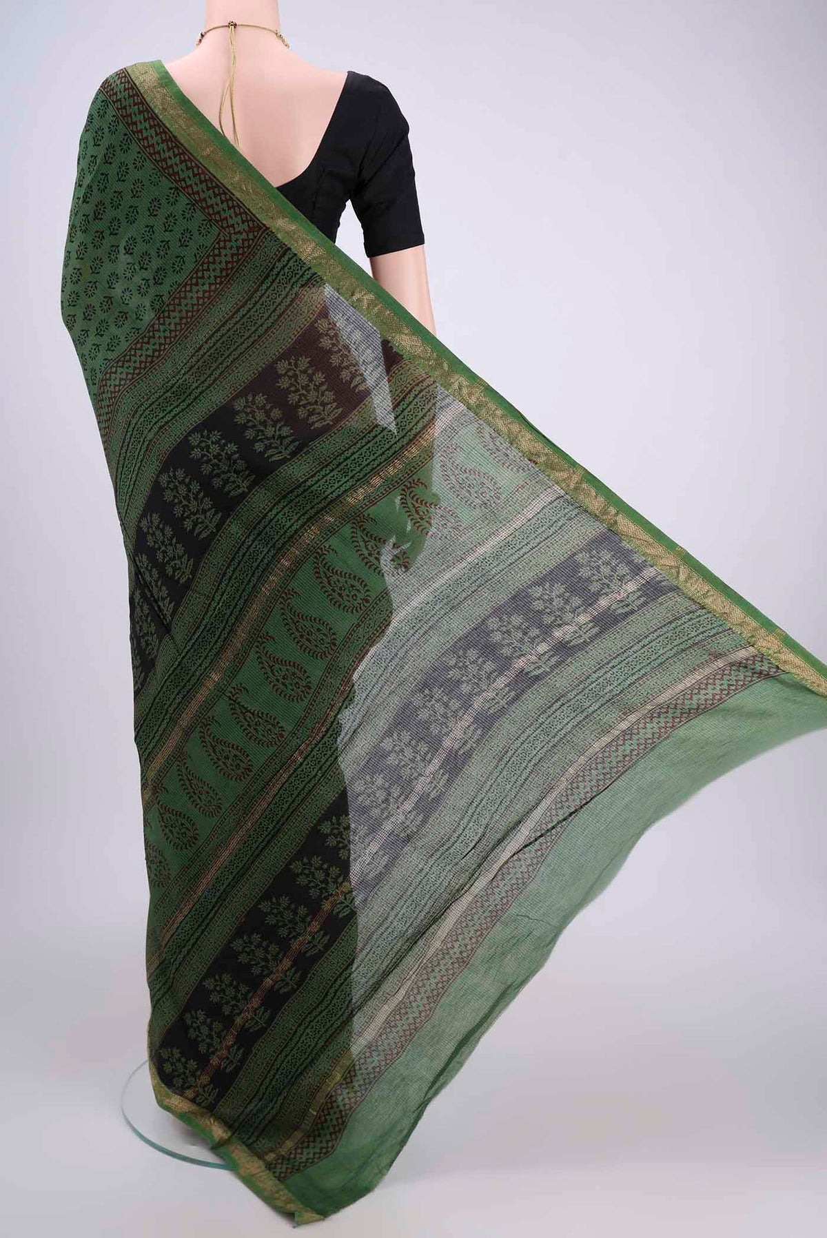 Flat view of Green Maheshwari Silk Cotton Saree with Batik Print on the body and Zari Border. 