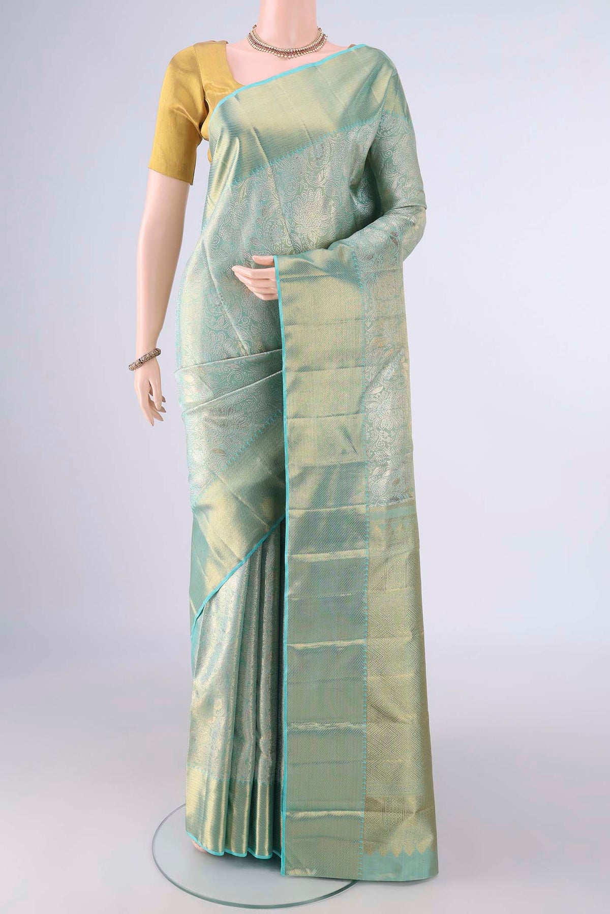 Pure Silk Pure Zari Turquoise Dual Tone Kanjivaram Tissue Saree with Zari Brocade on the body and Zari Border.  displayed on a mannequin