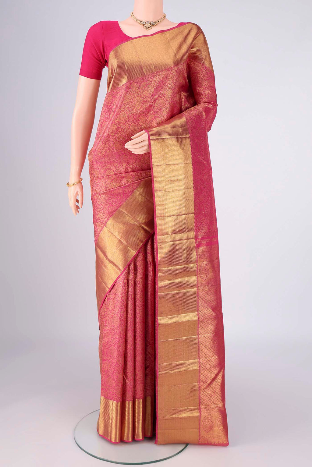 Pure Silk Pure Zari Pink Kanjivaram Saree with Zari Brocade on the body and Zari Border.  displayed on a mannequin