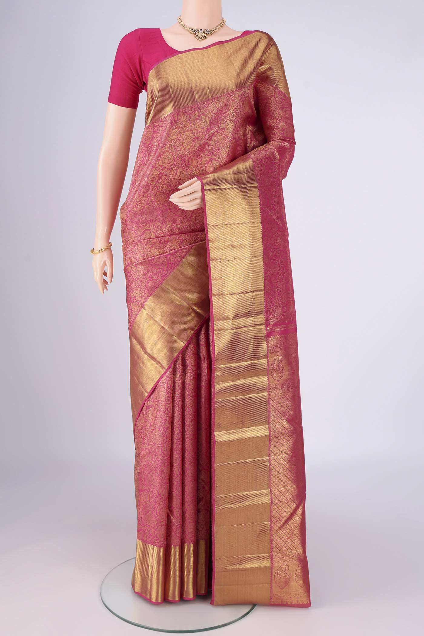 Pure Silk Pure Zari Pink Kanjivaram Saree with Zari Brocade on the body and Zari Border.  displayed on a mannequin