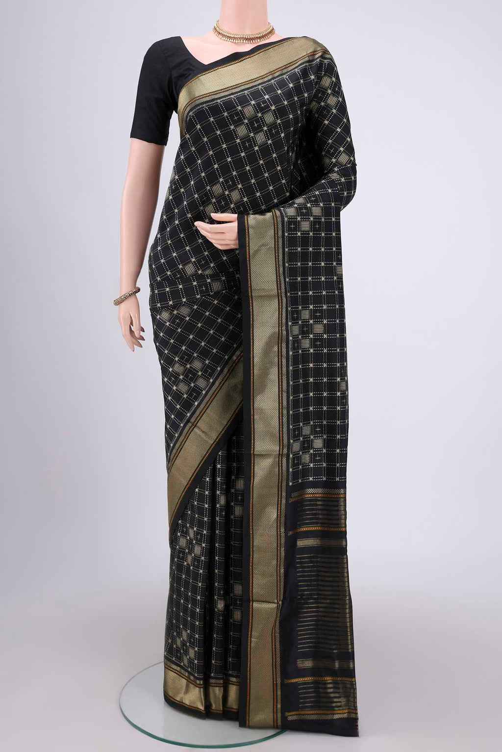 Black Pochampally Silk Saree with Checked design on the body and Zari Border.  displayed on a mannequin