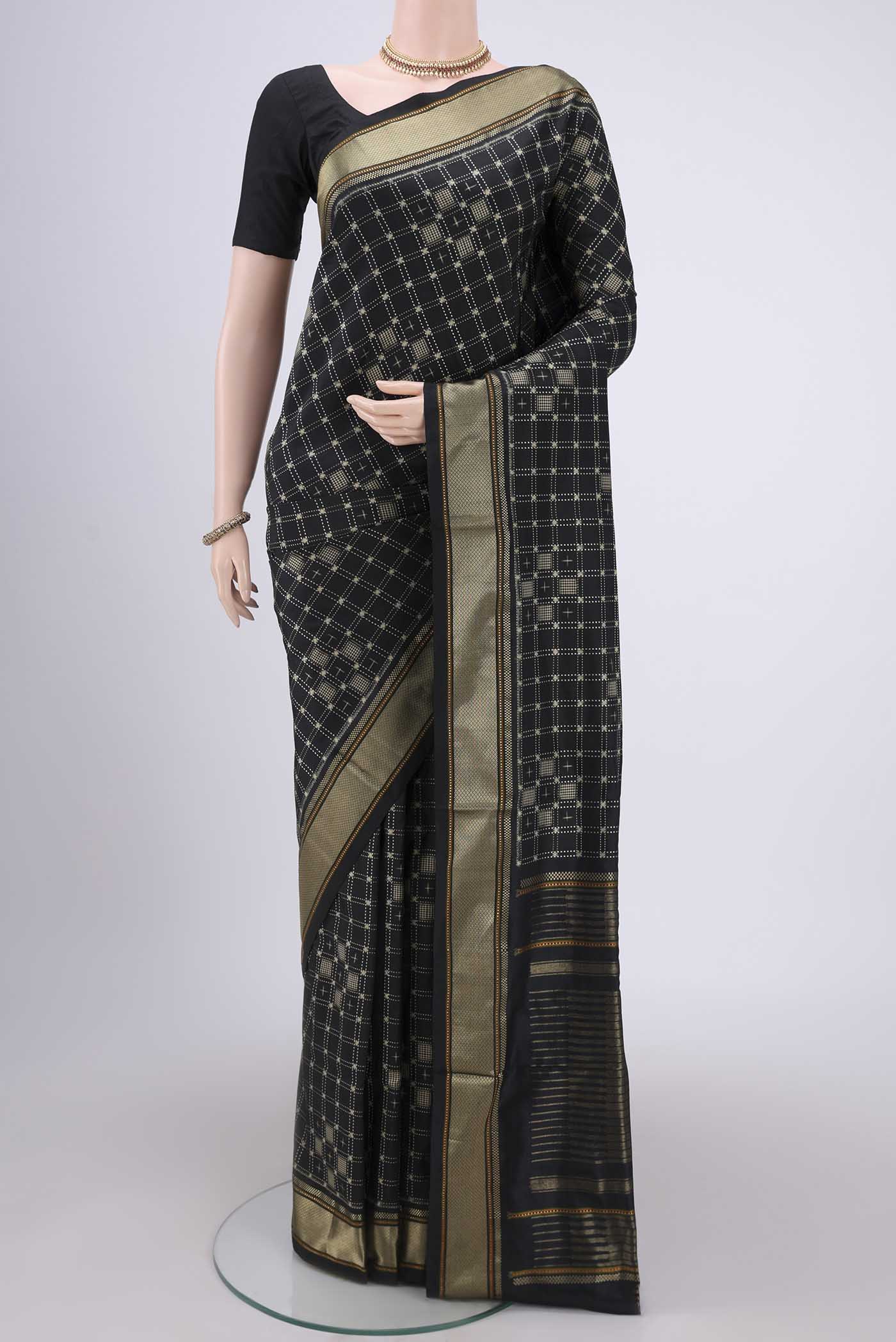 Black Pochampally Silk Saree with Checked design on the body and Zari Border.  displayed on a mannequin