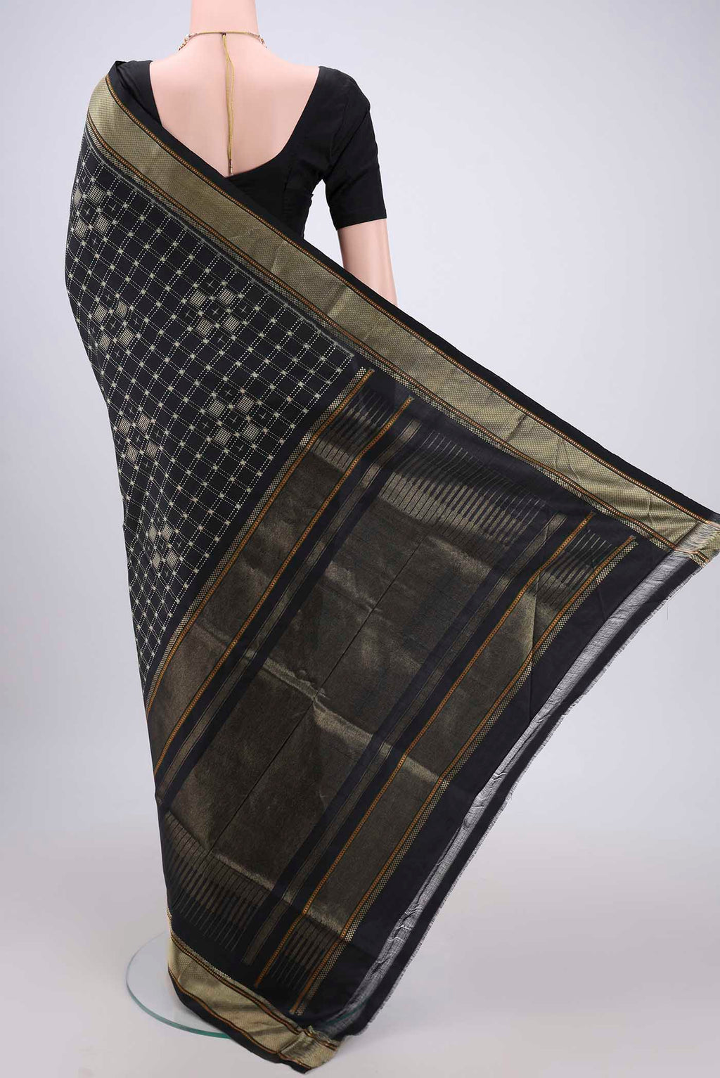 Flat view of Black Pochampally Silk Saree with Checked design on the body and Zari Border. 
