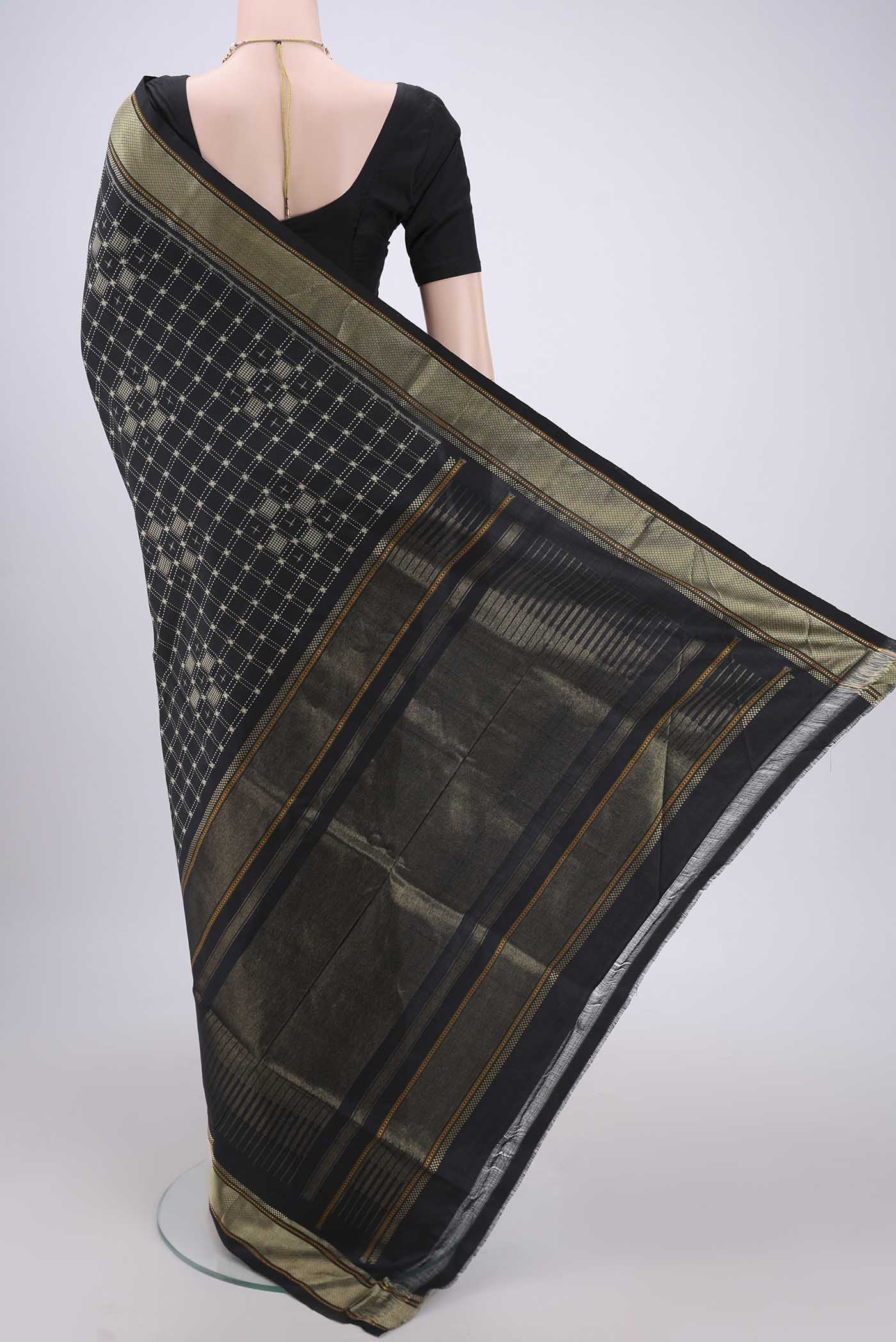 Flat view of Black Pochampally Silk Saree with Checked design on the body and Zari Border. 