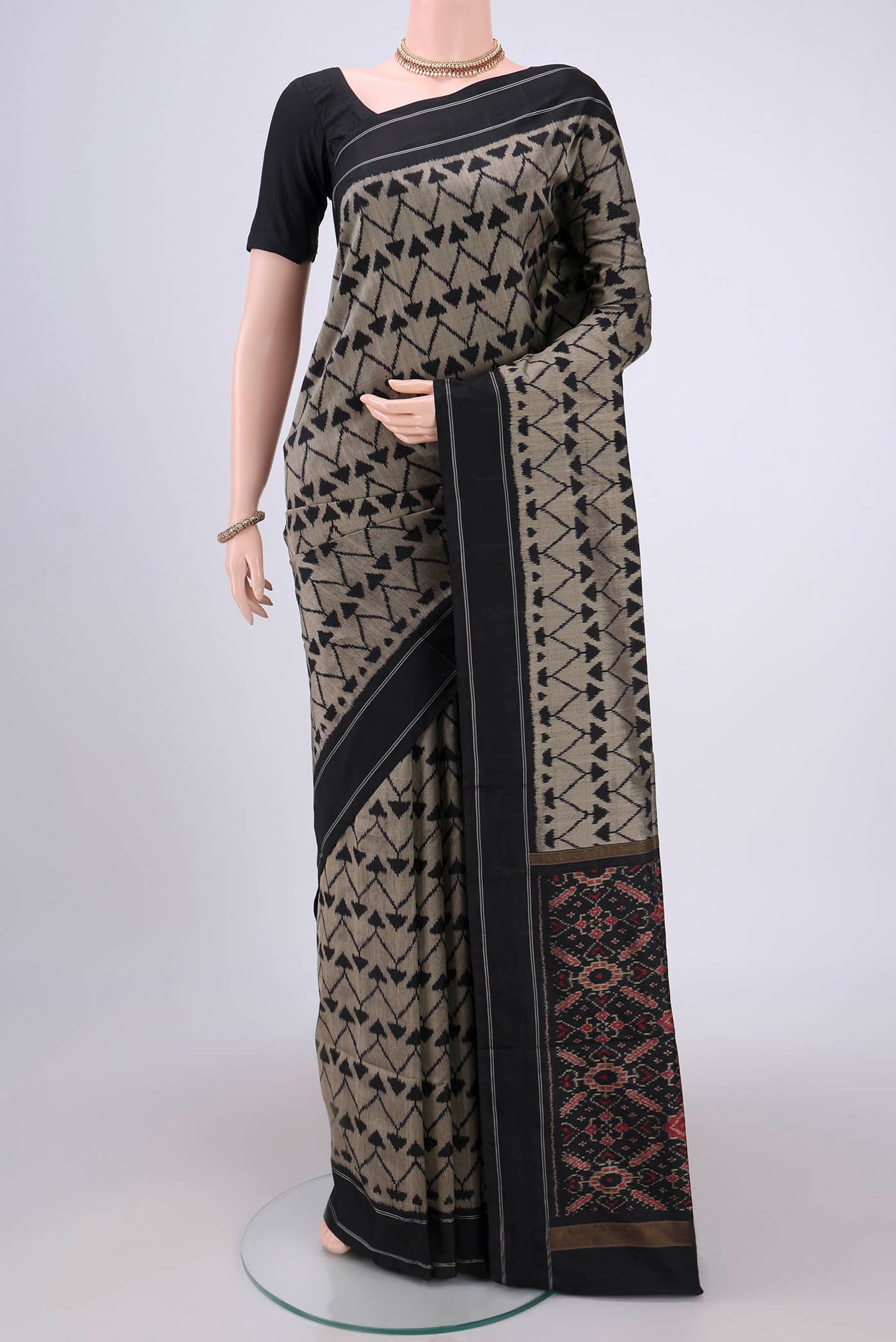 Davys Grey Pochampally Silk Saree with Ikat design on the body and Zari Border.  displayed on a mannequin
