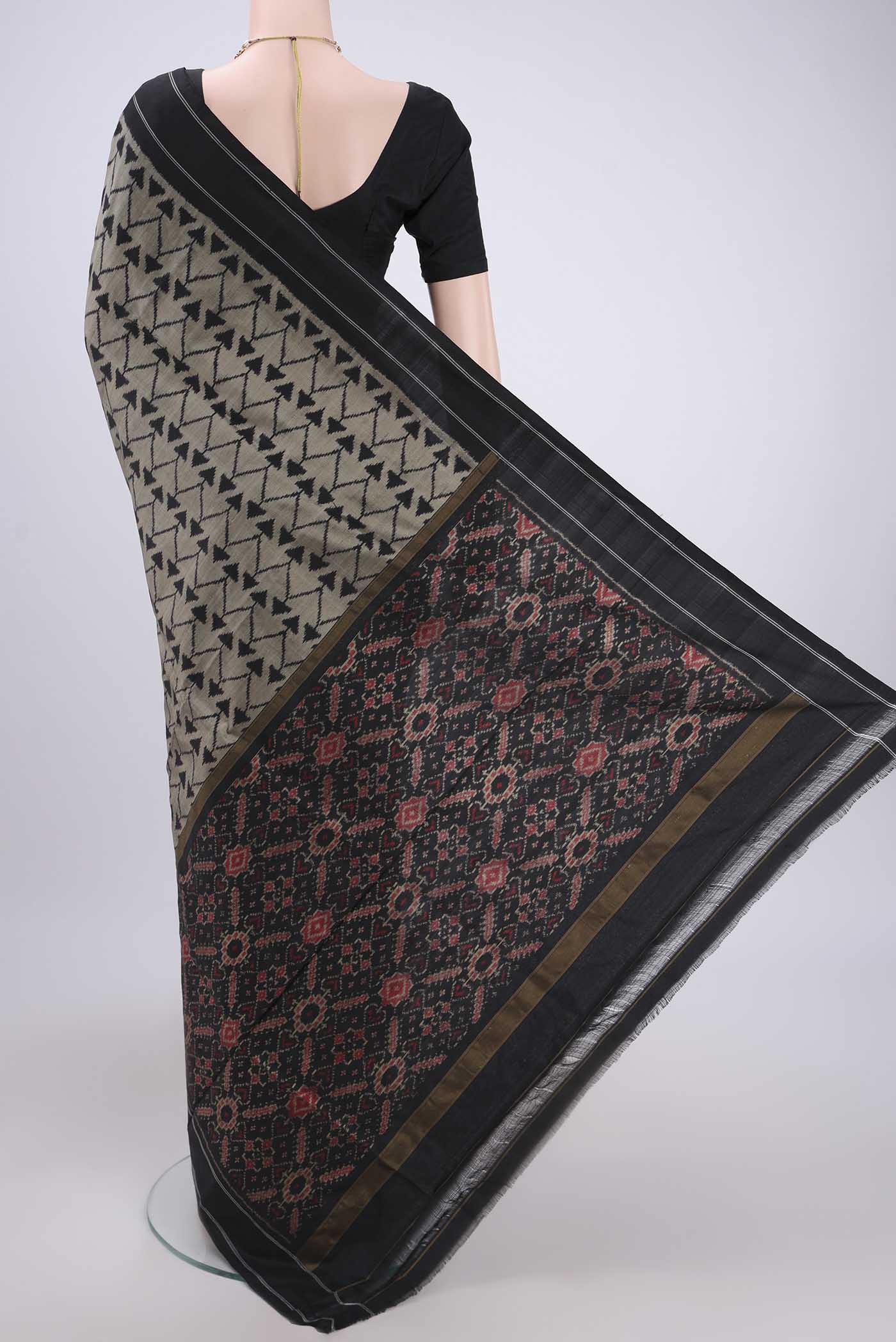 Flat view of Davys Grey Pochampally Silk Saree with Ikat design on the body and Zari Border. 