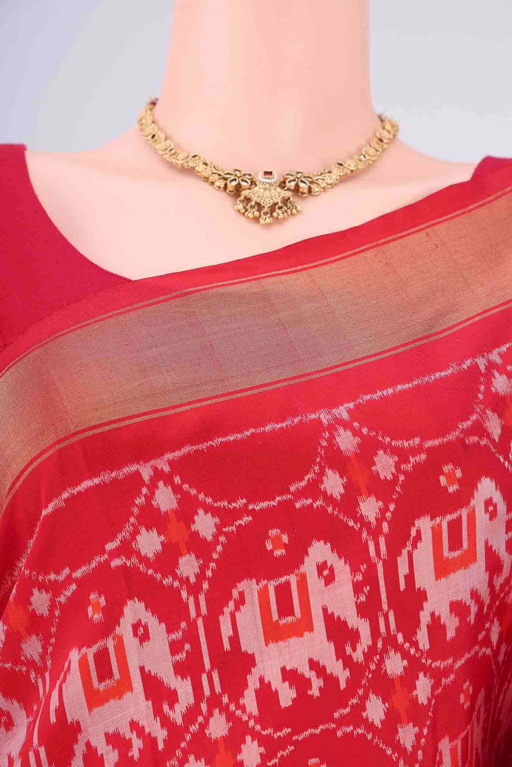 Border image of Red Pochampally Silk Saree with Ikat design on the body and Zari Border. 