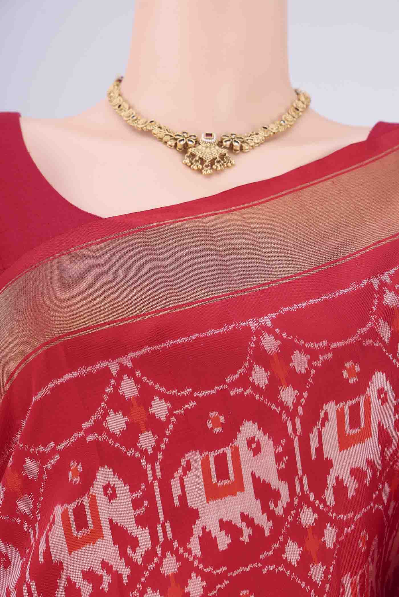 Border image of Red Pochampally Silk Saree with Ikat design on the body and Zari Border. 