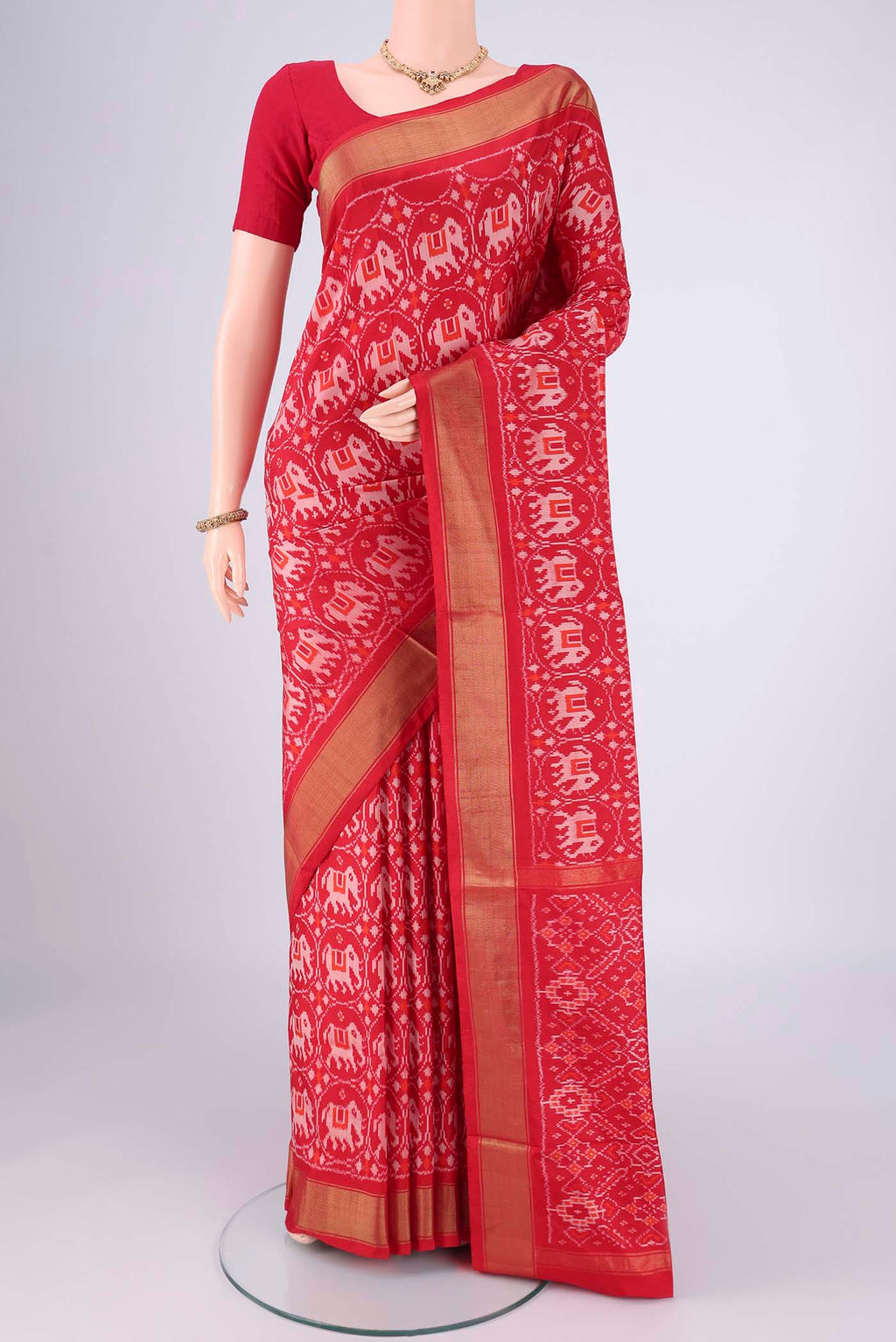 Red Pochampally Silk Saree with Ikat design on the body and Zari Border.  displayed on a mannequin