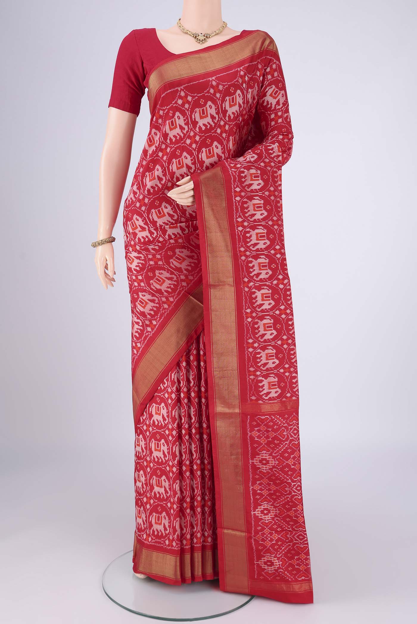 Red Pochampally Silk Saree with Ikat design on the body and Zari Border.  displayed on a mannequin