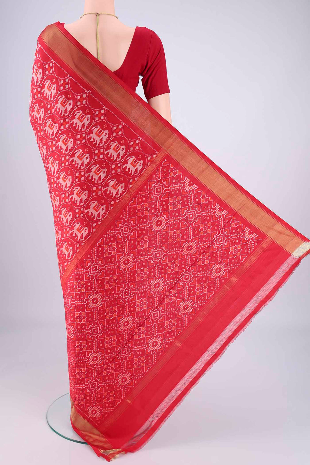 Flat view of Red Pochampally Silk Saree with Ikat design on the body and Zari Border. 