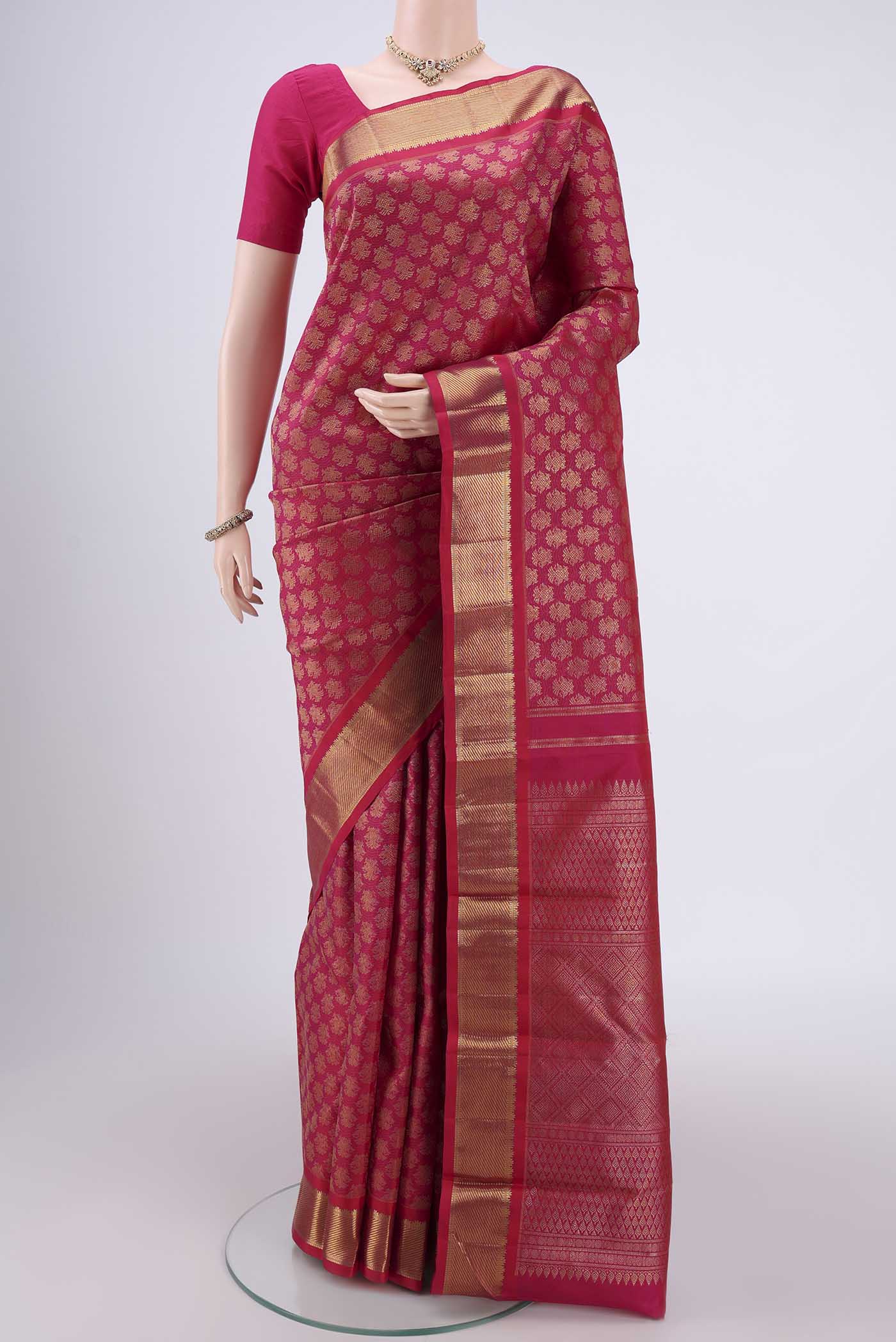 Pure Silk Pure Zari Rani Pink Kanjivaram Saree with Zari Butta on the body and Zari Border.  displayed on a mannequin