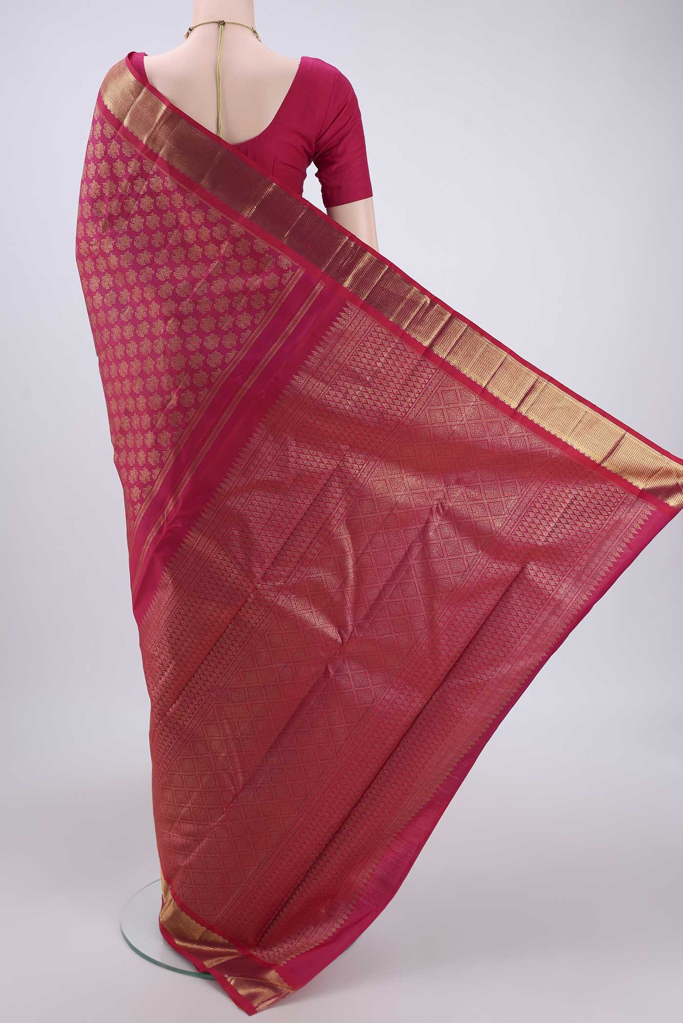 Flat view of Pure Silk Pure Zari Rani Pink Kanjivaram Saree with Zari Butta on the body and Zari Border. 