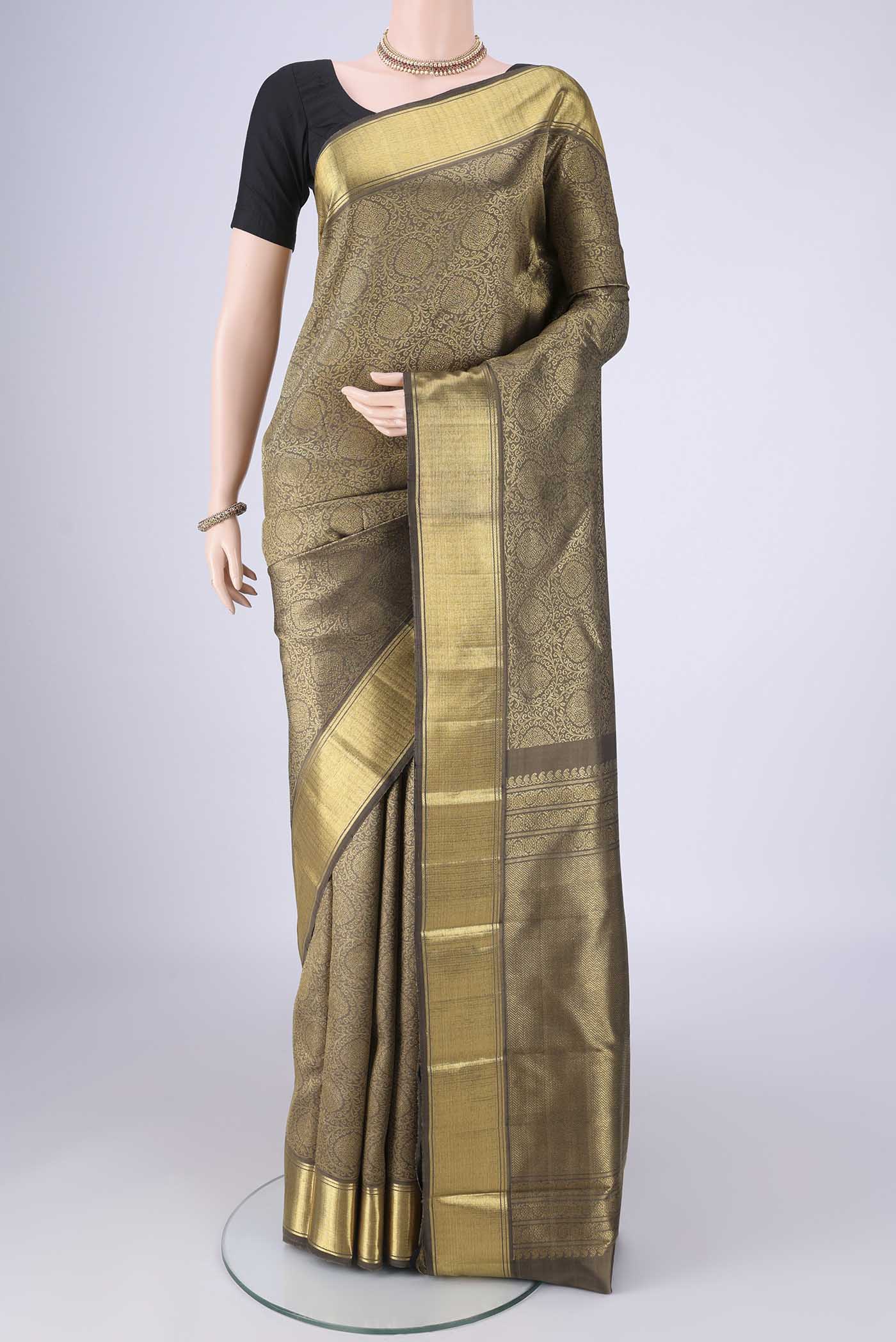 Pure Silk Pure Zari Davys Grey Kanjivaram Saree with Zari Butta on the body and Zari Border.  displayed on a mannequin