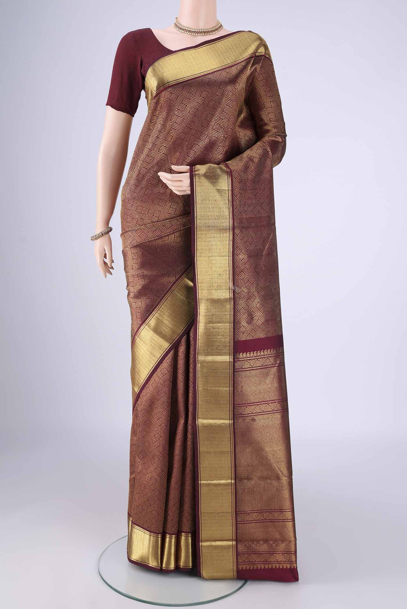Pure Silk Pure Zari Maroon Kanjivaram Saree with Zari Brocade on the body and Zari Border.  displayed on a mannequin
