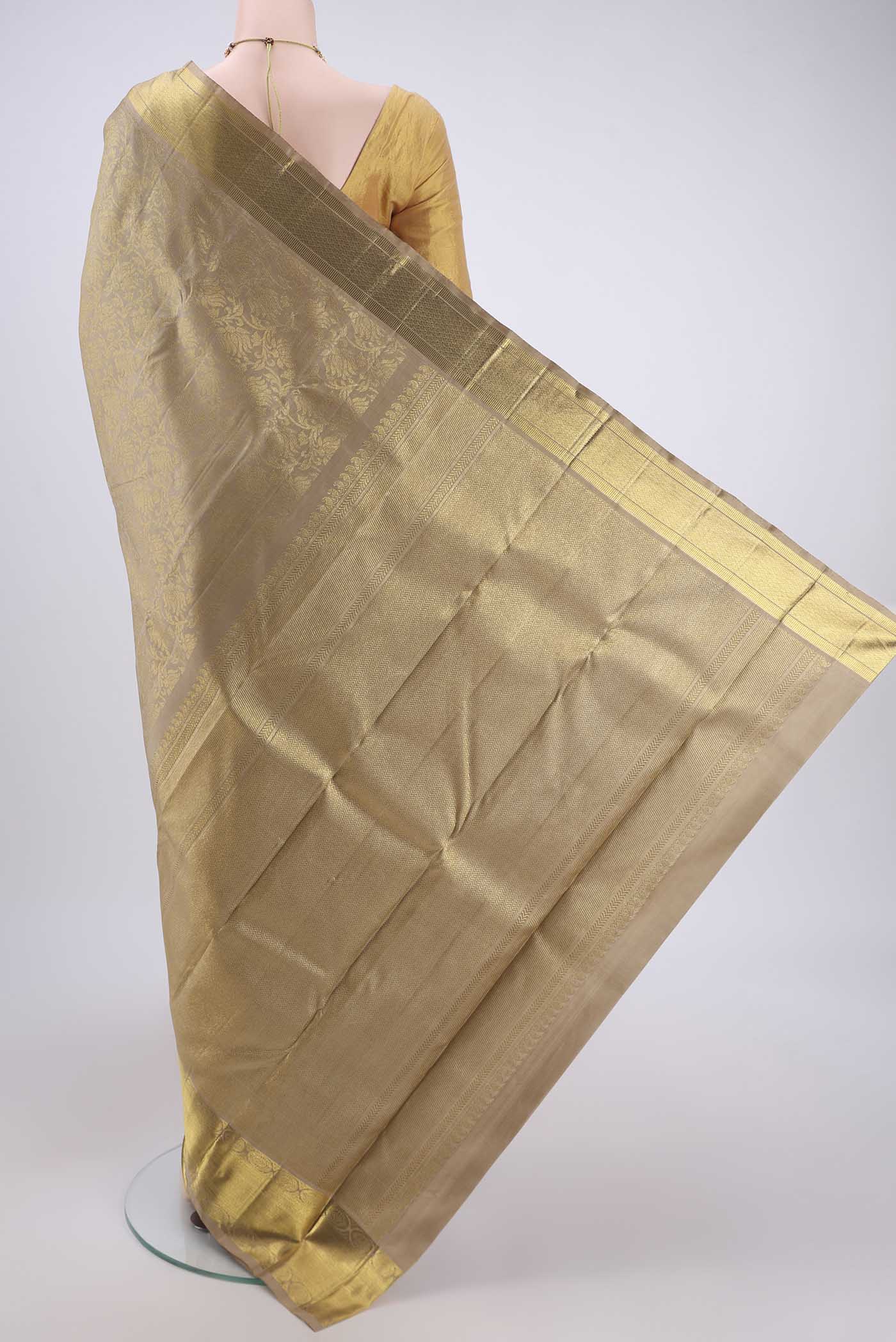 Flat view of Pure Silk Pure Zari Beige Kanjivaram Saree with Zari Butta on the body and Zari Border. 