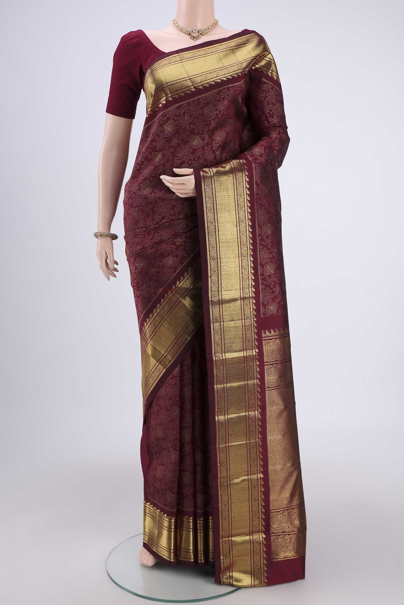 Pure Silk Pure Zari Brown Kanjivaram Saree with Zari Butta on the body and Zari Border.  displayed on a mannequin