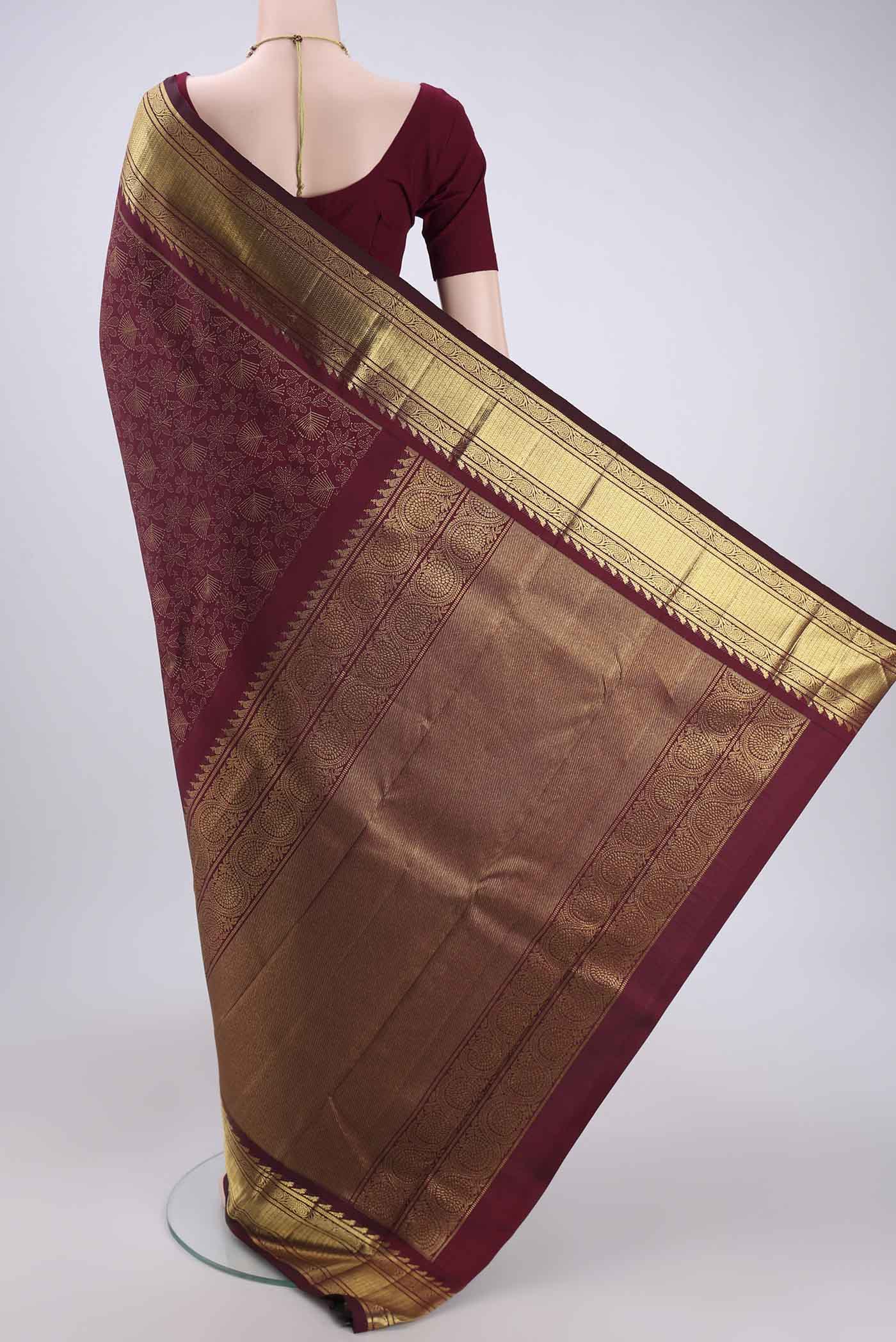 Flat view of Pure Silk Pure Zari Brown Kanjivaram Saree with Zari Butta on the body and Zari Border. 