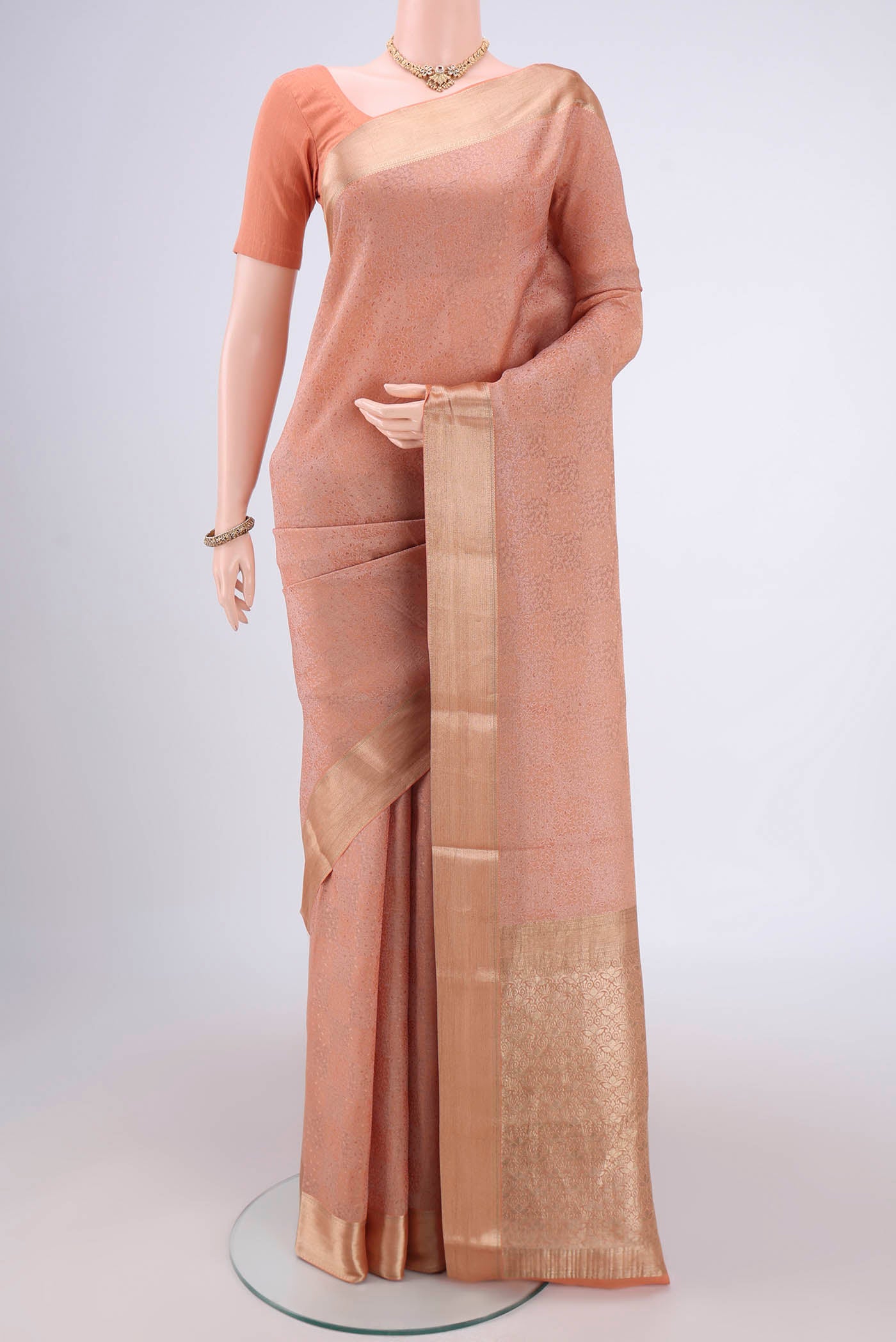 Golden Peach Mysore Georgette Saree with Jacquard design on the body and Zari Border.  displayed on a mannequin