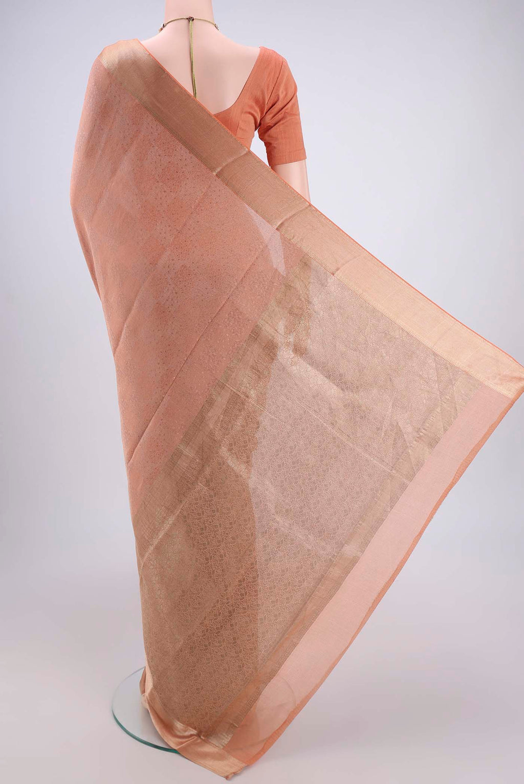 Flat view of Golden Peach Mysore Georgette Saree with Jacquard design on the body and Zari Border. 