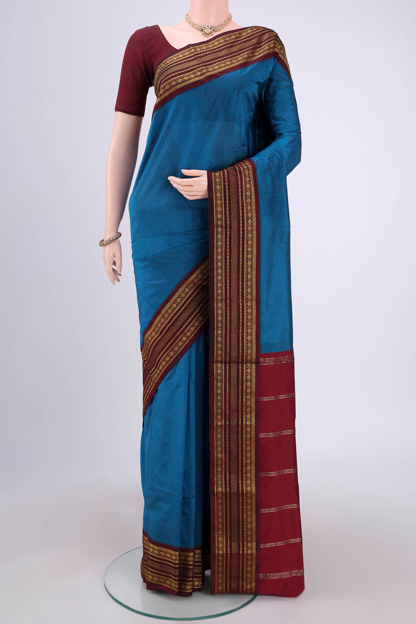 Dark Blue Blended Bangalore Silk Saree with Plain Body and Zari Border.  displayed on a mannequin