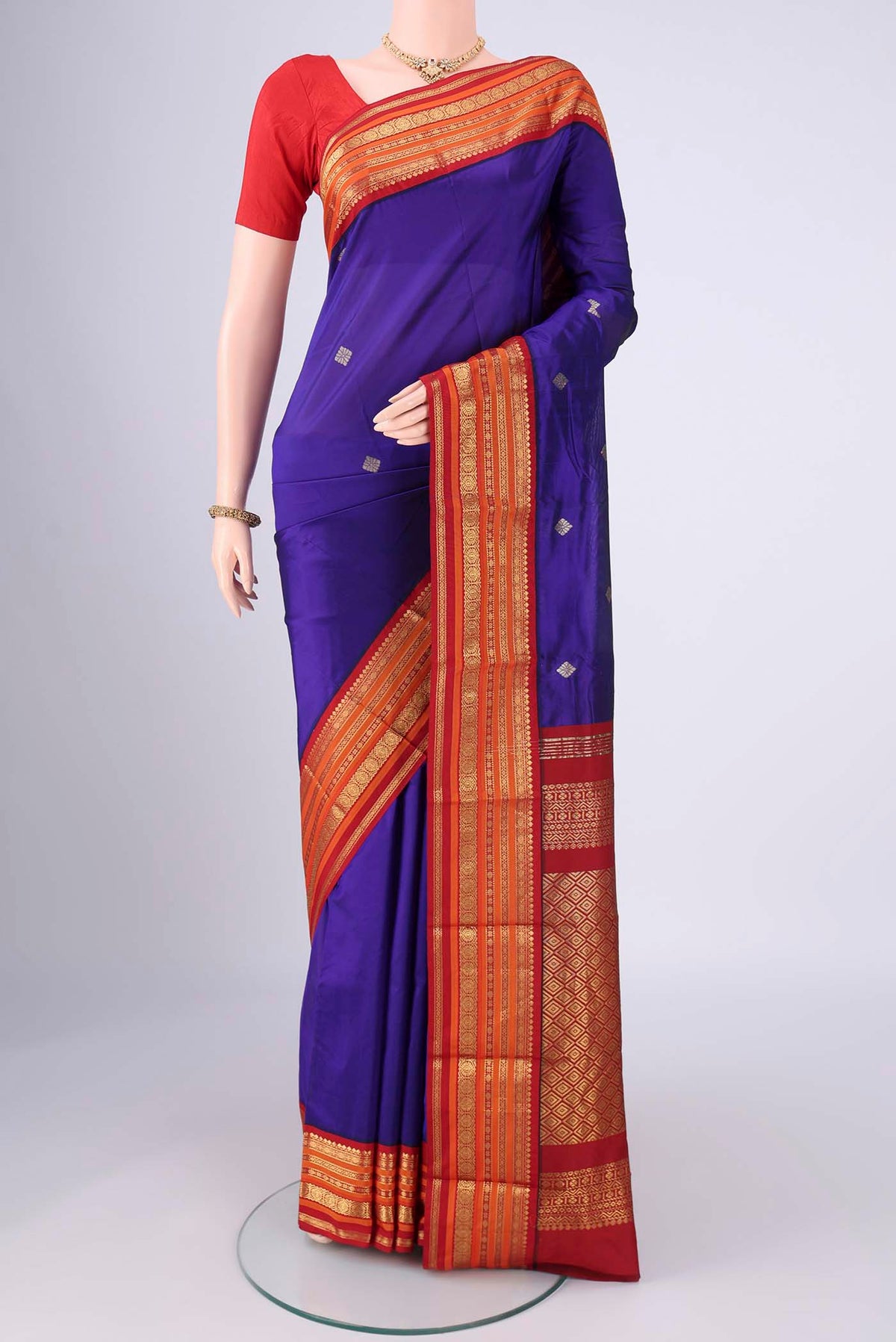 Purple Blended Bangalore Silk Saree with Zari Butta on the body and Zari Border.  displayed on a mannequin
