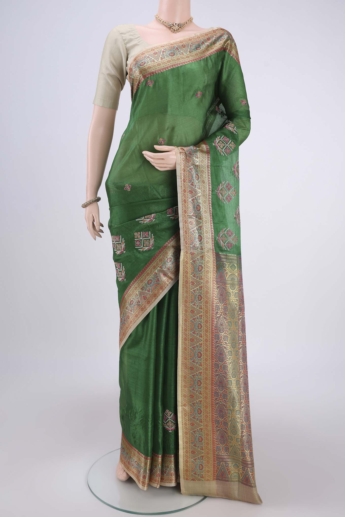 Green Banarasi Tussar Silk Saree with Embroidery on the body and Zari And Thread Border.  displayed on a mannequin
