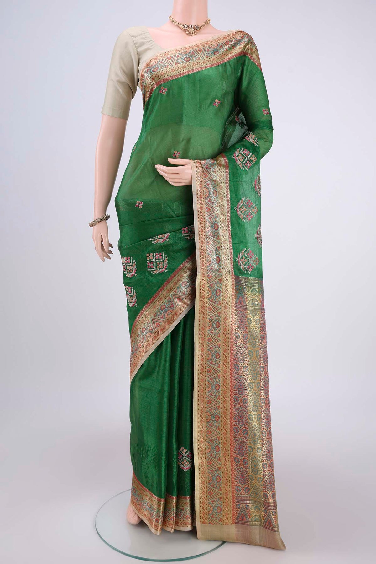 Green Banarasi Tussar Silk Saree with Embroidery on the body and Zari And Thread Border.  displayed on a mannequin