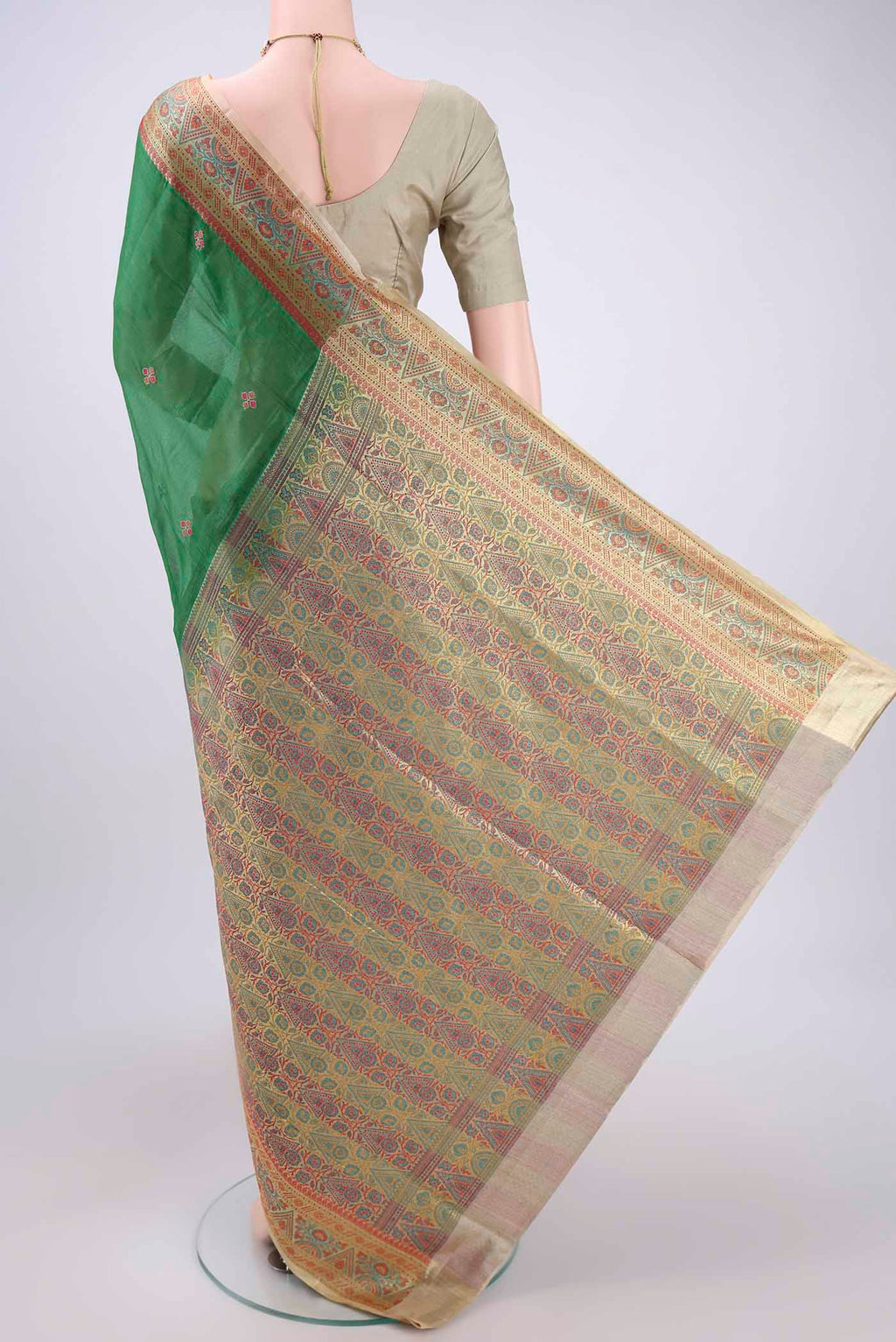 Flat view of Green Banarasi Tussar Silk Saree with Embroidery on the body and Zari And Thread Border. 