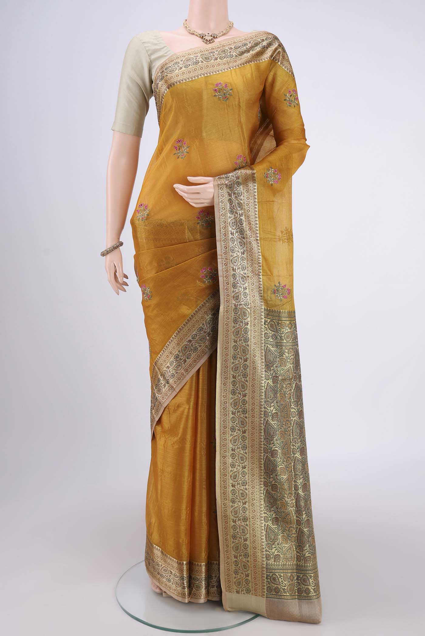Yellow Banarasi Tussar Silk Saree with Embroidery on the body and Zari And Thread Border.  displayed on a mannequin