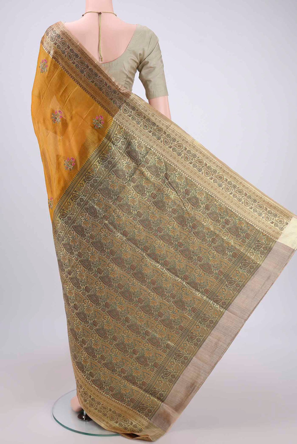 Flat view of Yellow Banarasi Tussar Silk Saree with Embroidery on the body and Zari And Thread Border. 