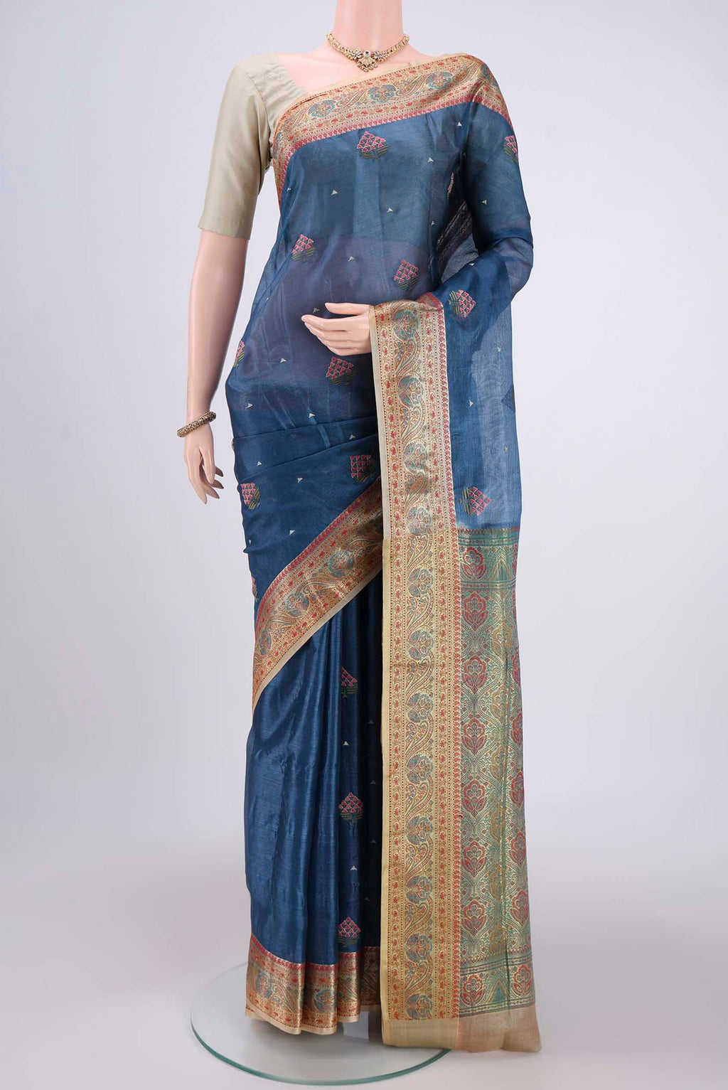 Electric Blue Banarasi Tussar Silk Saree with Embroidery on the body and Zari And Thread Border.  displayed on a mannequin