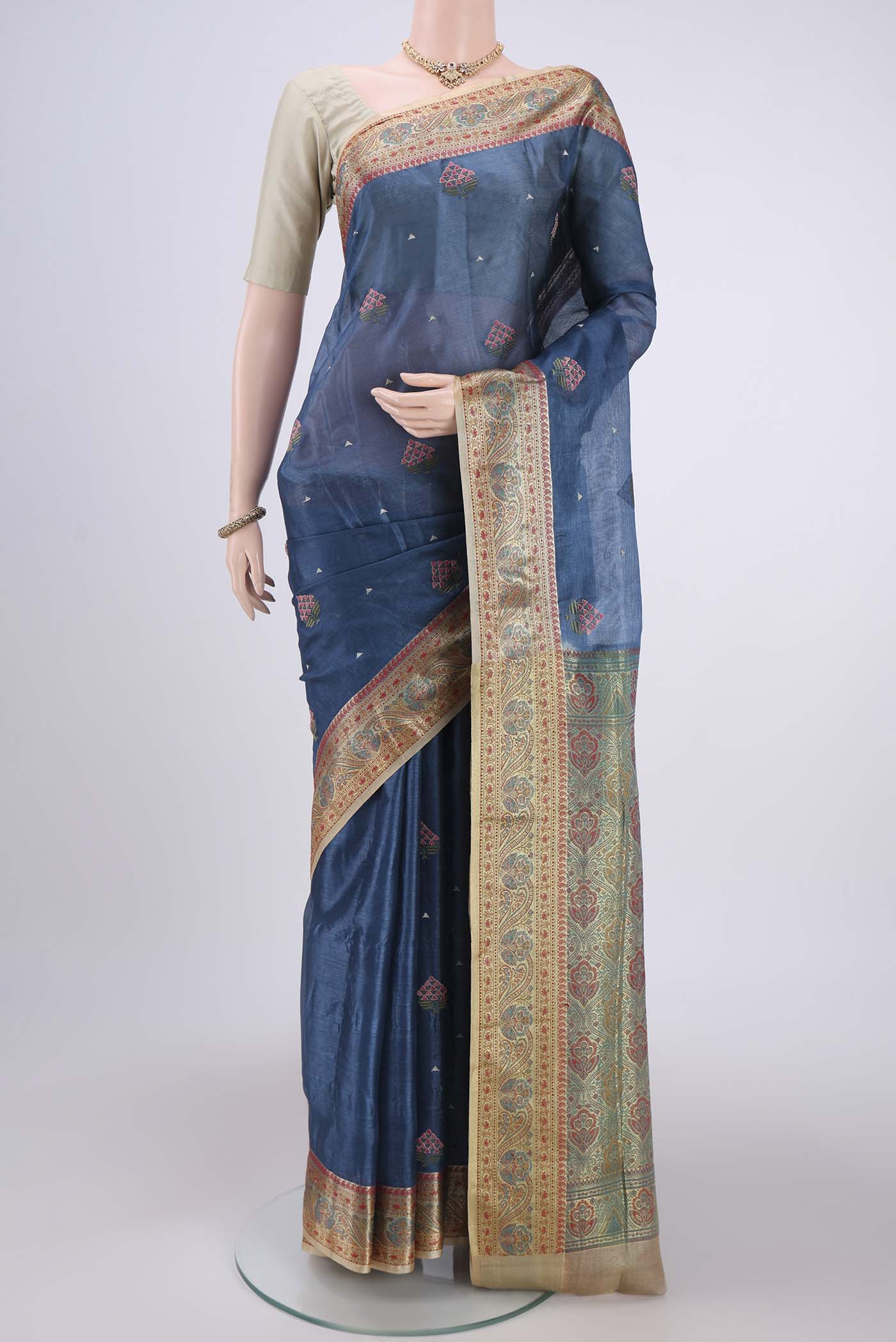 Electric Blue Banarasi Tussar Silk Saree with Embroidery on the body and Zari And Thread Border.  displayed on a mannequin
